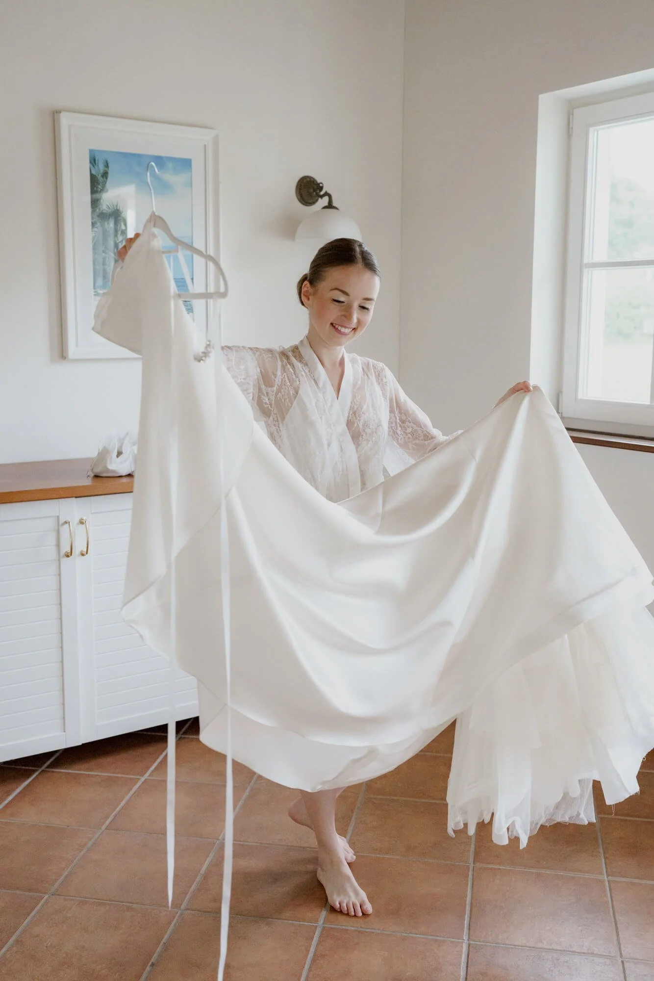 Bride is holding wedding dress