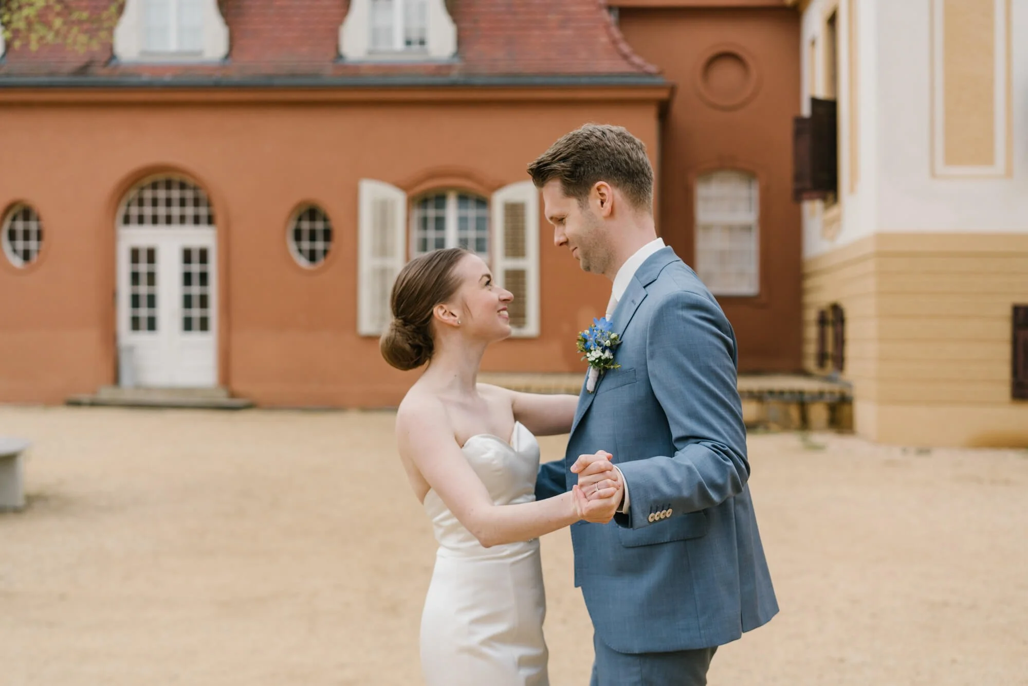 wedding couple is dancing in Schloss Caputh square in Potsdam area