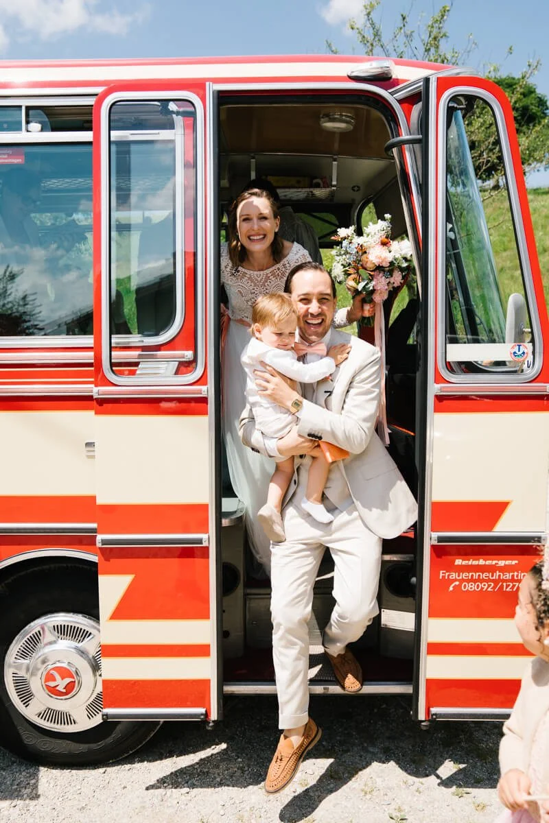 Retro car school bus for wedding ceremony rental in Munich. Couple is going out from a retro bus on the wedding day