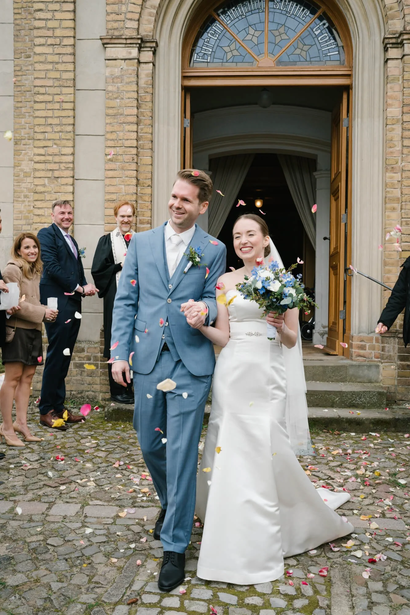 wedding couple exiting Dorfkirche Caputh with Rosses