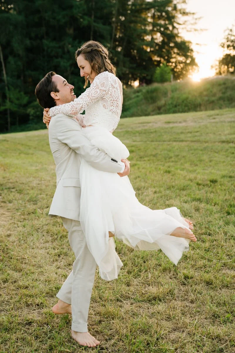 groom is holding and turning around his bride during sunset in Munich