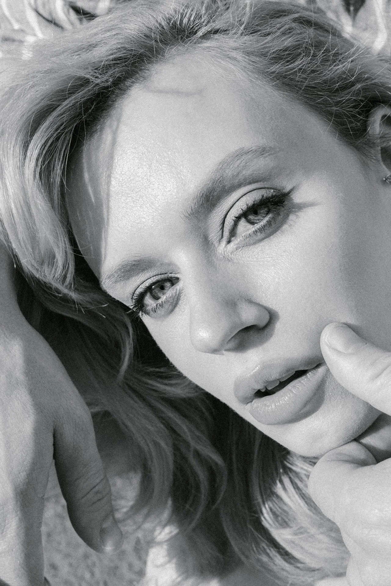 Close up portrait of a girl with boyfriends hand on the cheek