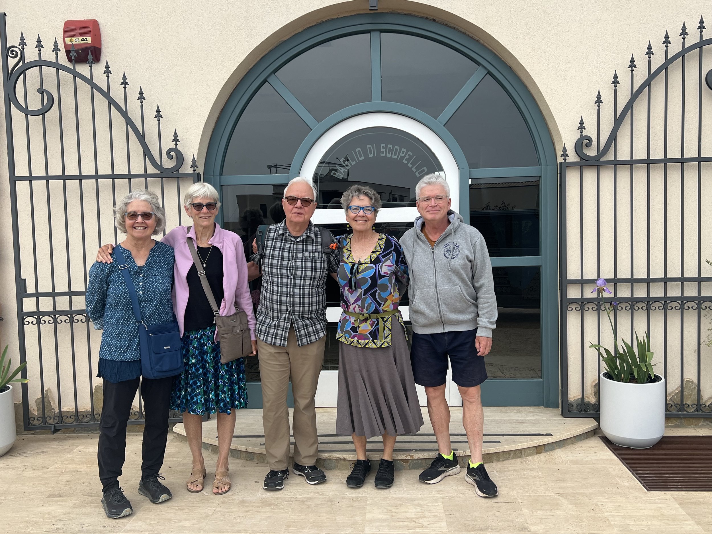 The Juergens cousins and Jay pose post-hike outside their Scopello hotel.