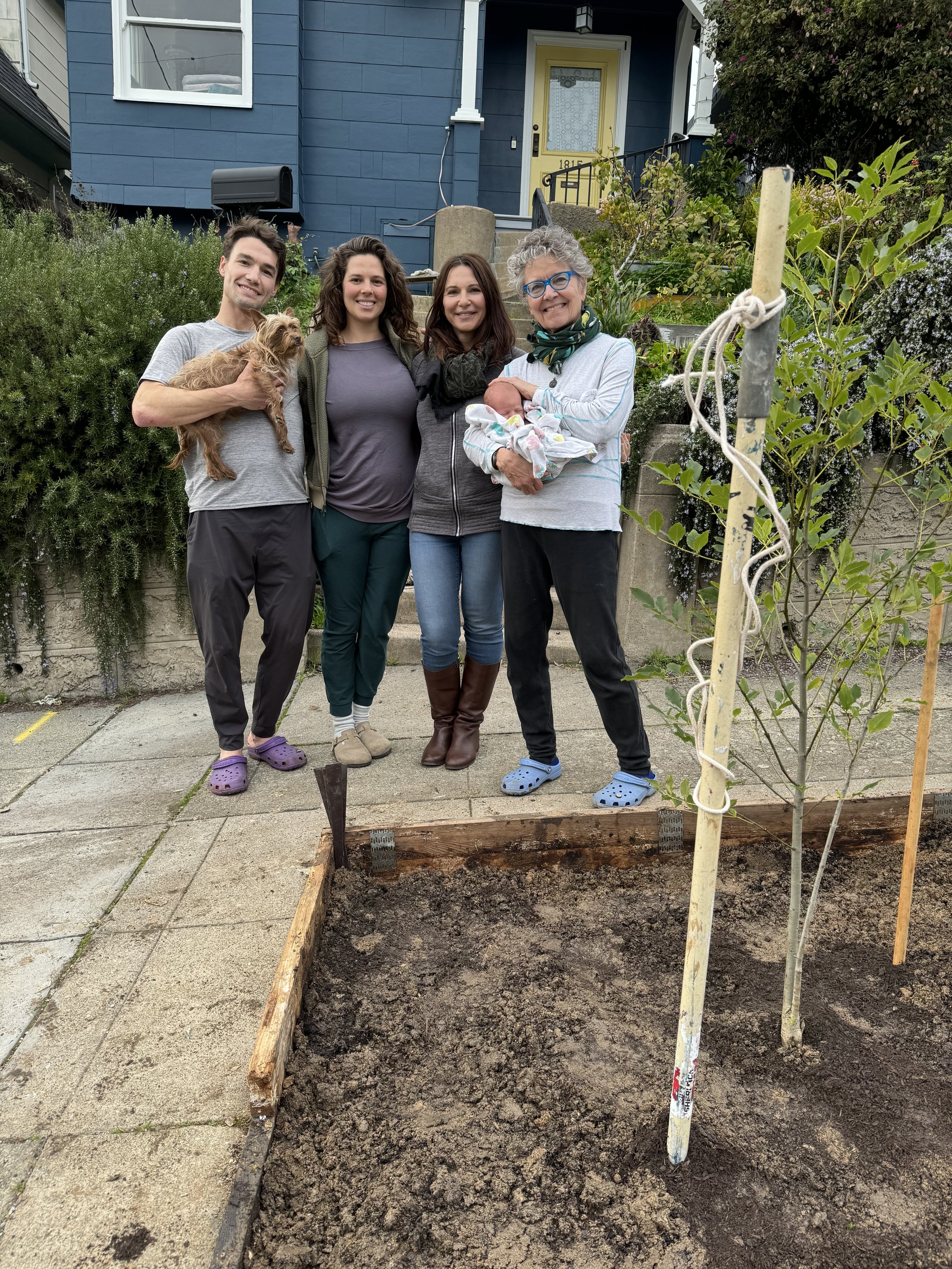 Planting a tree in January outside of Altai's house, in his honor, with the two grandmothers