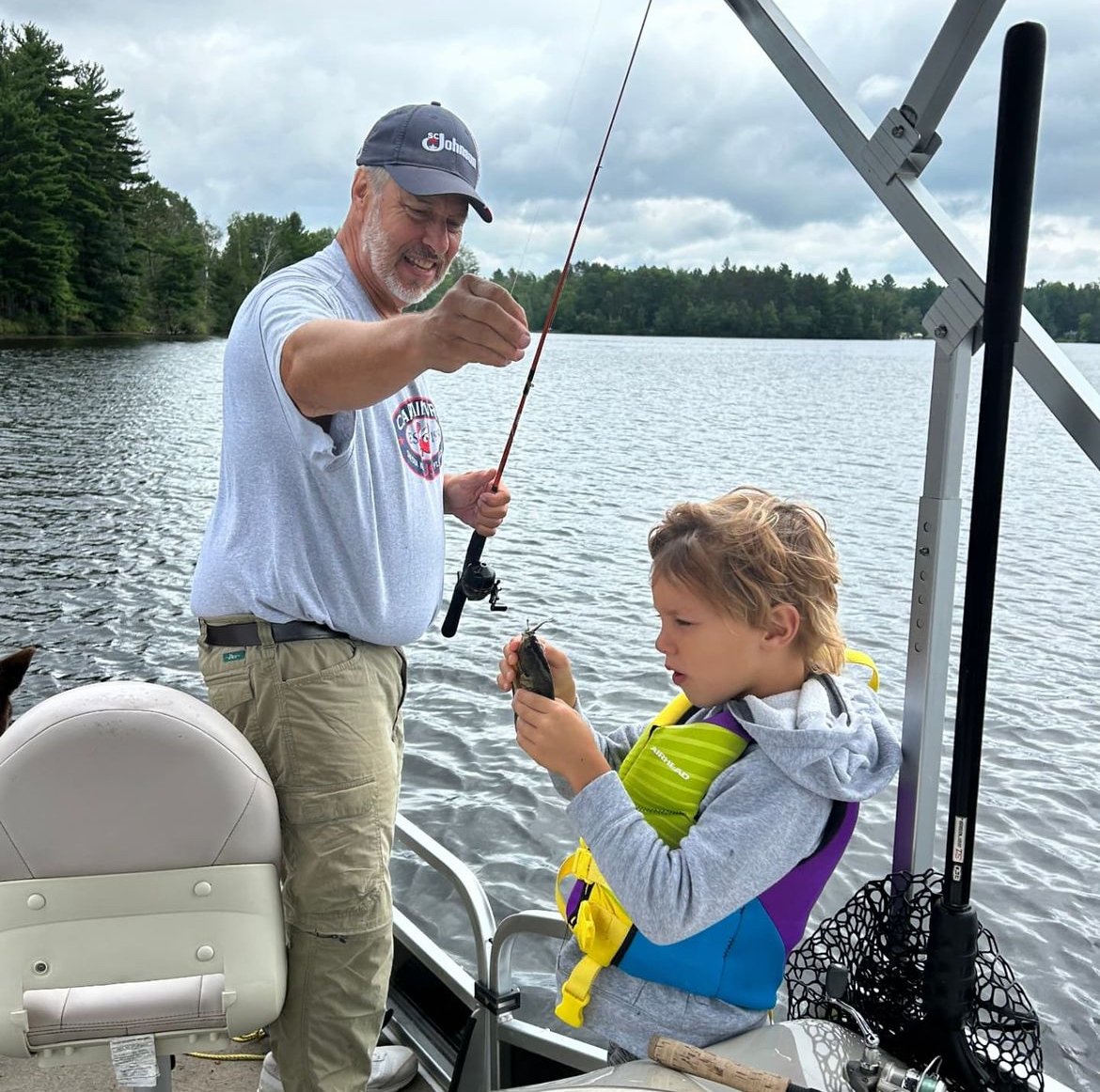 Auggie caught a fish in Hayward with Grandpa Hill