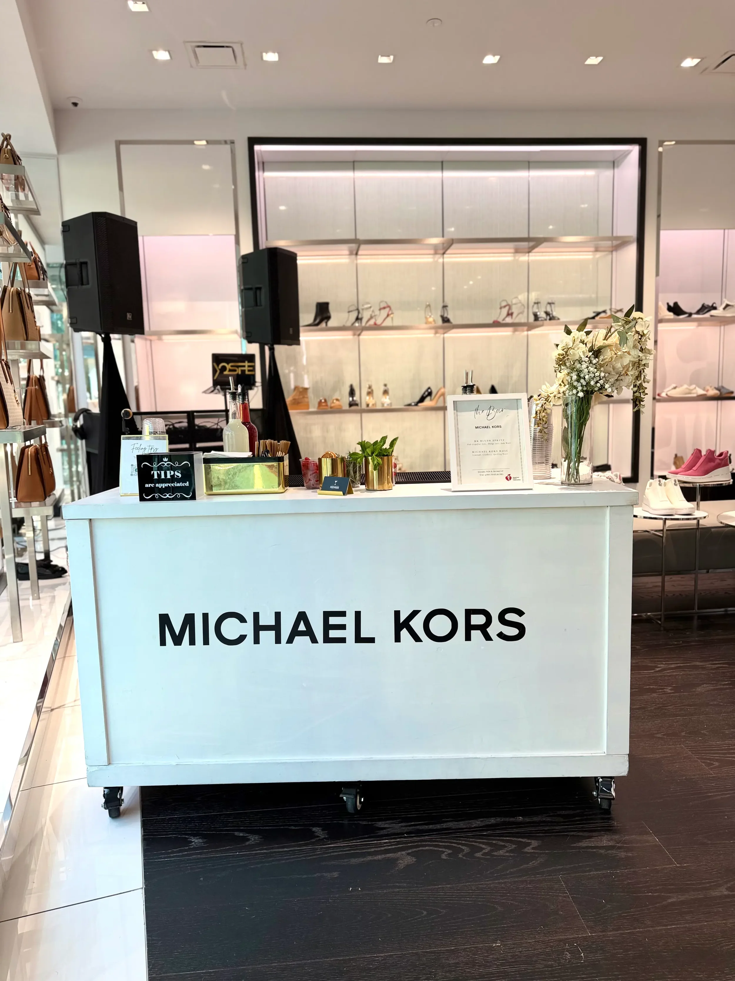 Branded mobile bar setup for a Michael Kors retail brand activation in The Mall Millennial, Orlando featuring custom cocktails, professional bartenders, and luxury event styling