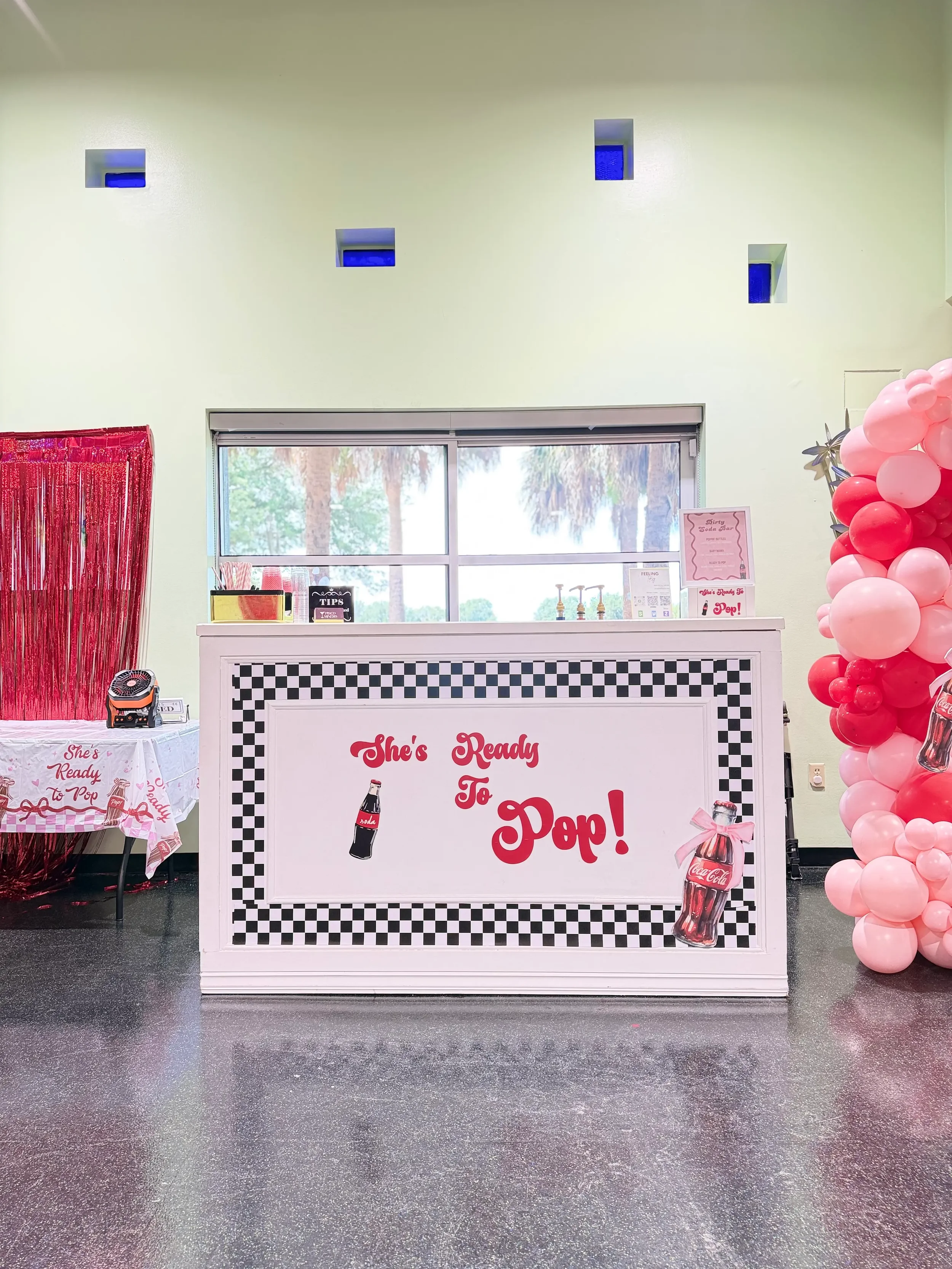 Custom mobile dirty soda bar for a "She's Ready to Pop" baby shower in Orlando, featuring personalized event décor, themed branding, and handcrafted specialty sodas.