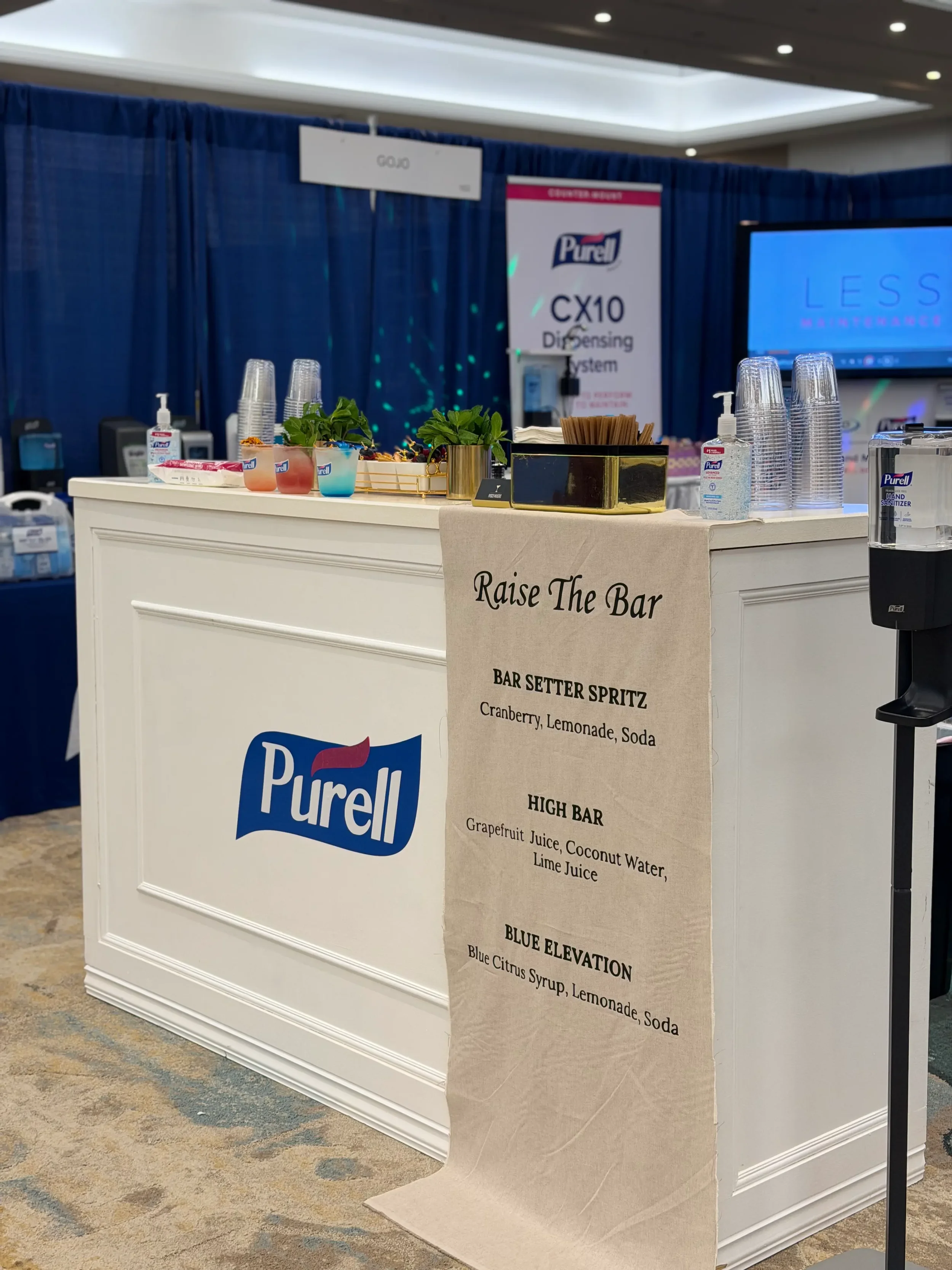 Custom branded mobile mocktail bar for PURELL at a corporate trade show in Orlando, featuring branded drinks, custom cups, a linen menu, and a fully wrapped bar setup.