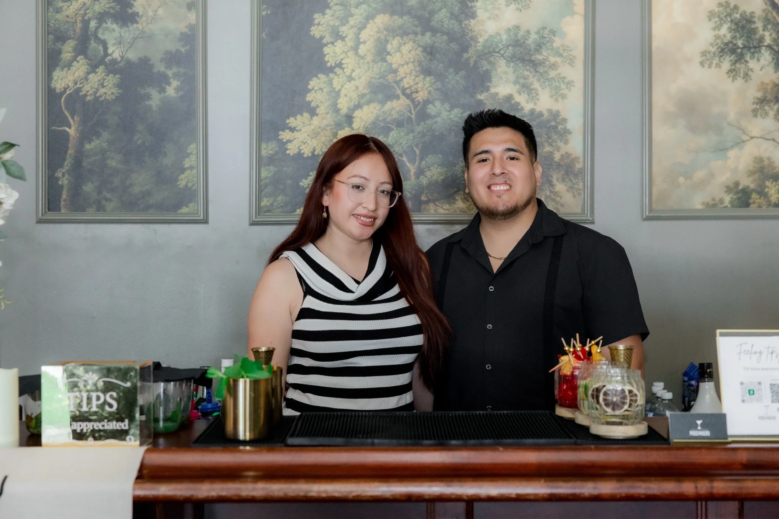 The Pisco Mixers team, Solange and Jefri, posing behind their custom mobile bar while serving weddings, corporate events, and private parties in Central Florida.