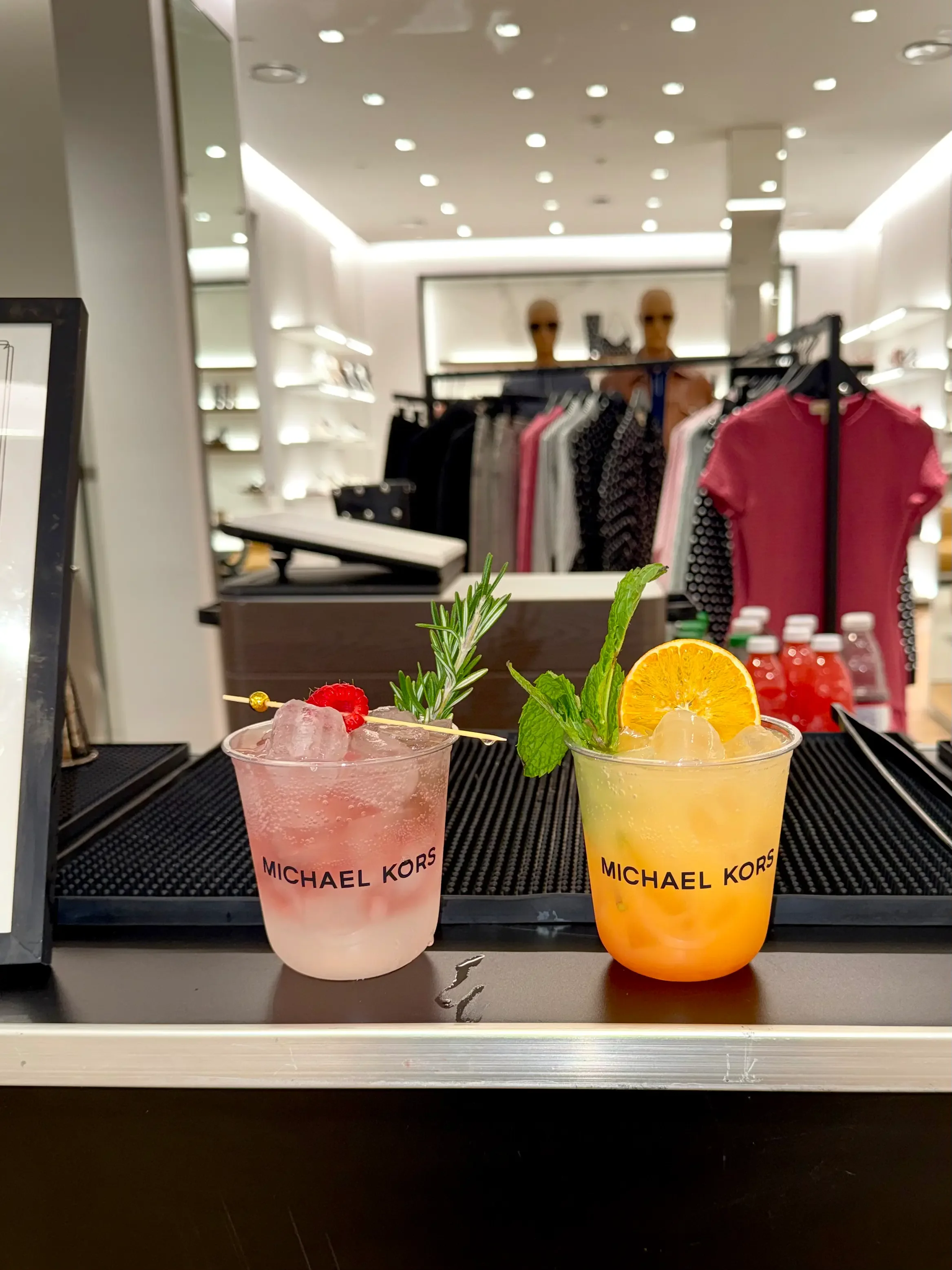 Signature mocktails served in custom Michael Kors branded cups during a luxury retail brand activation, creating an elevated guest experience by Pisco Mixers.