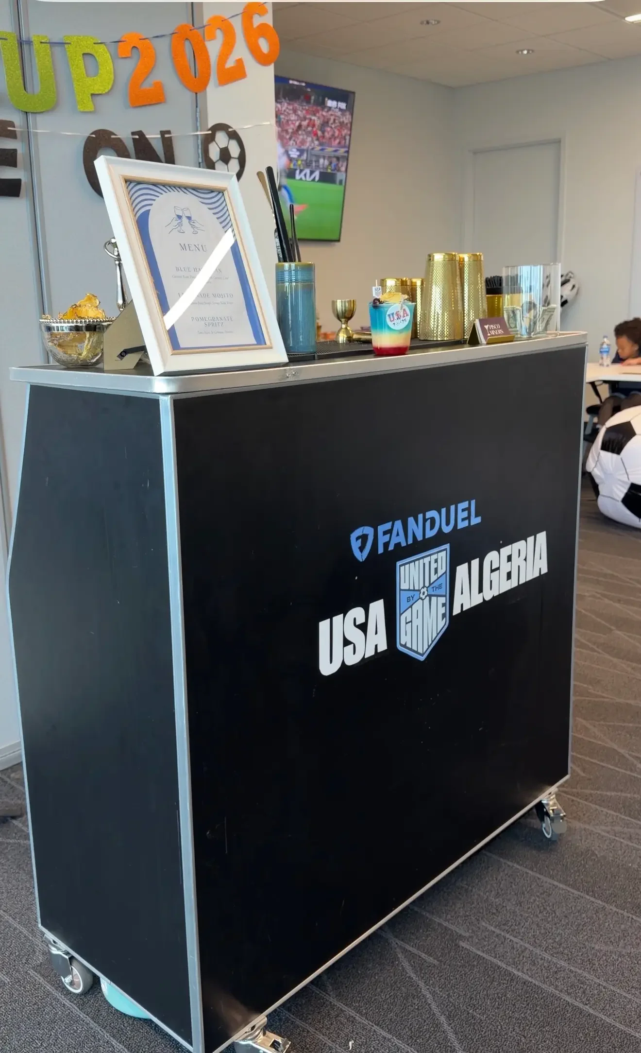 Custom black mobile bar featuring the FanDuel logo during a FIFA corporate watch party in Orlando, designed for employee engagement with signature cocktails and personalized event branding.
