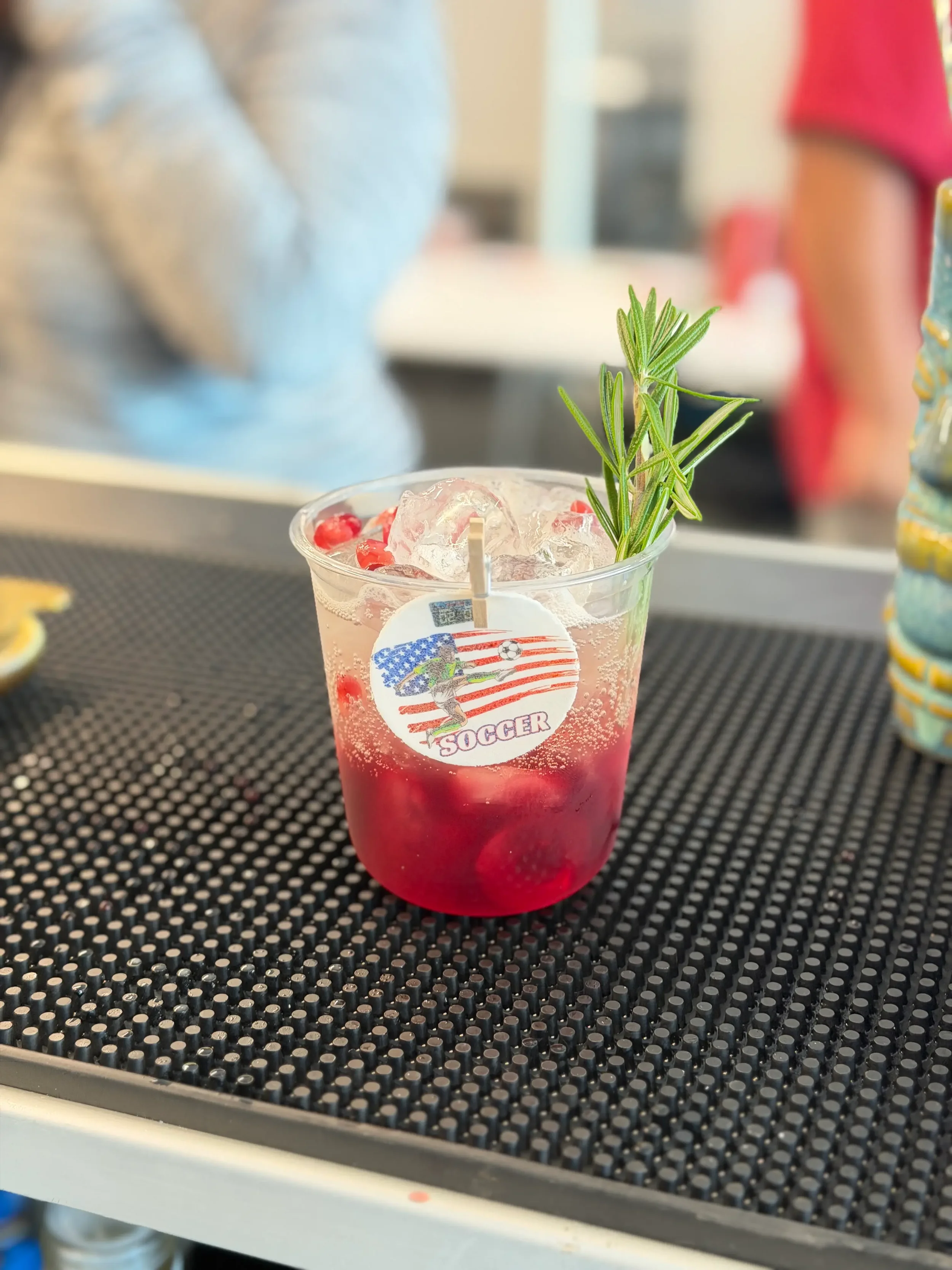 Custom signature spritz created for FanDuel's FIFA corporate watch party in Orlando, featuring rosemary garnish, personalized drink toppers, and a premium presentation for an employee happy hour.
