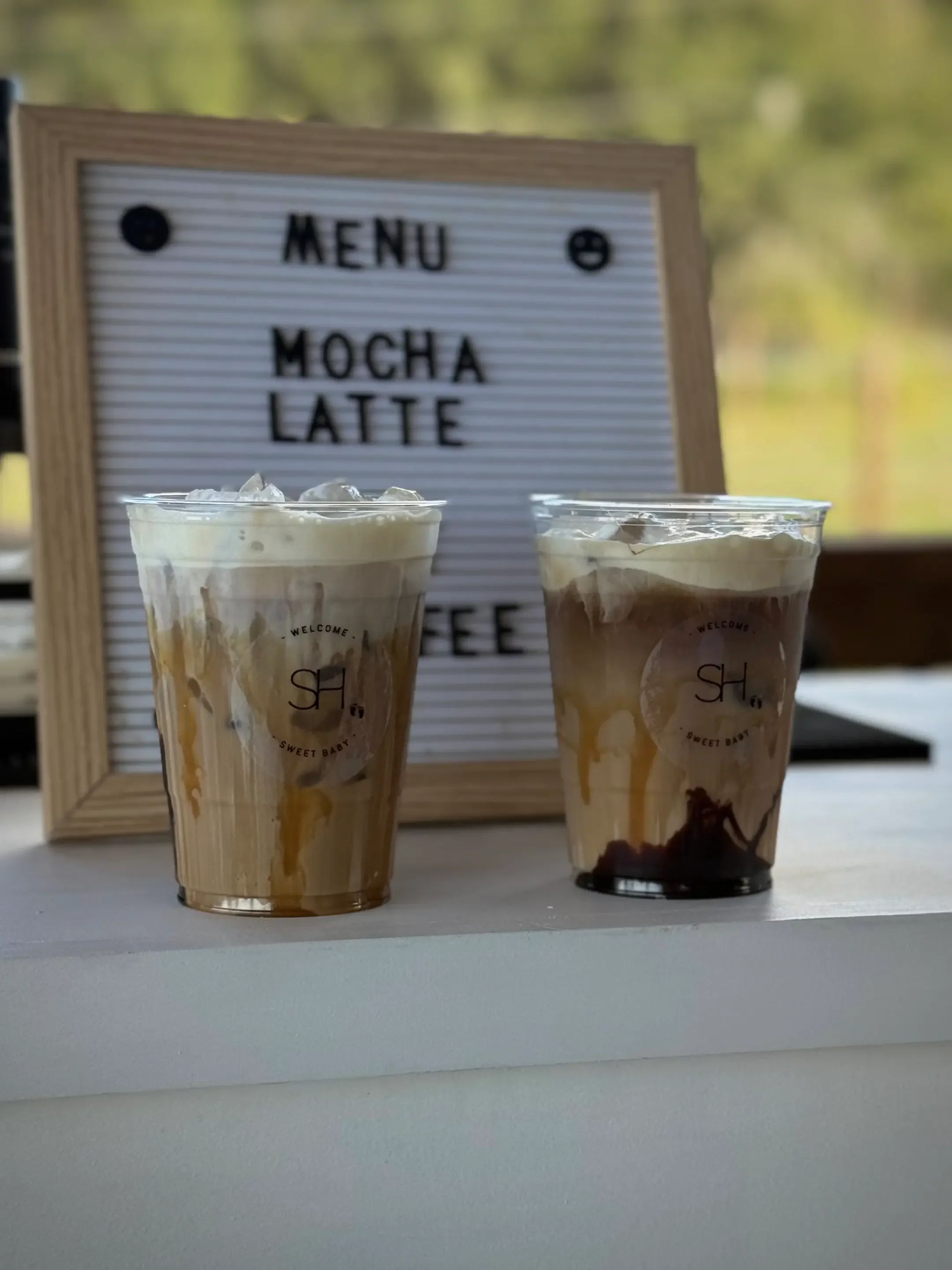 Handcrafted mocha latte served in a custom branded cup, showcasing personalized coffee bar service for weddings, corporate events, and brand activations by Pisco Mixers.