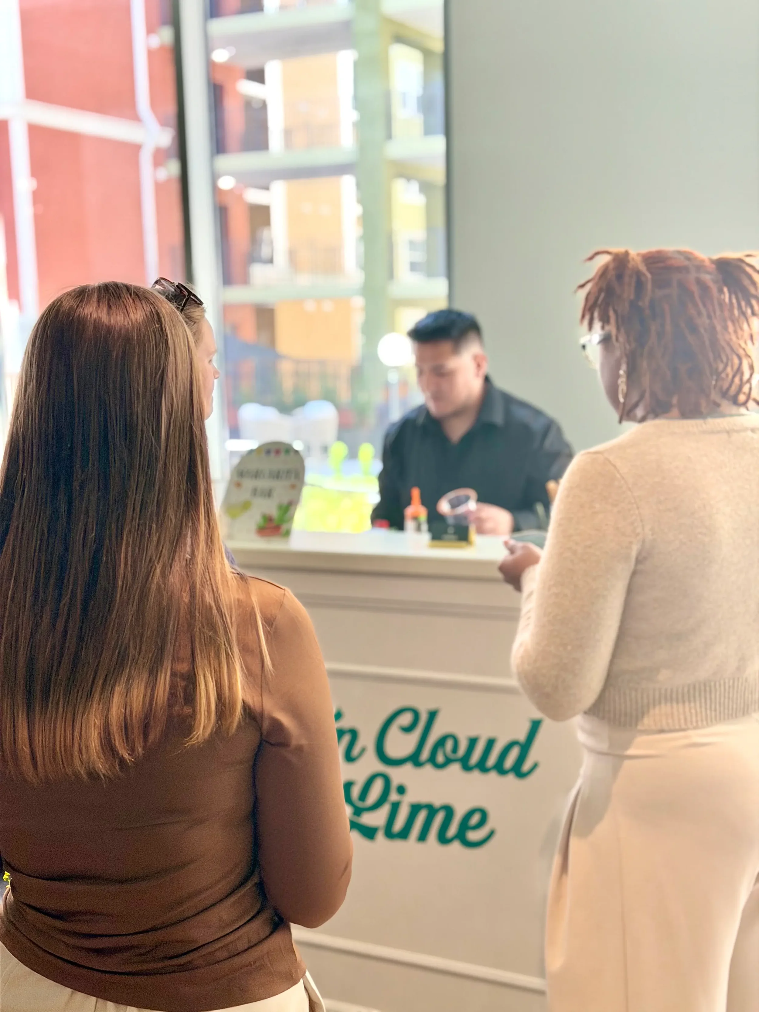 Professional bartender serving employees from a custom-branded mobile mocktail bar during an On Cloud Lime corporate lunch break event in Orlando.