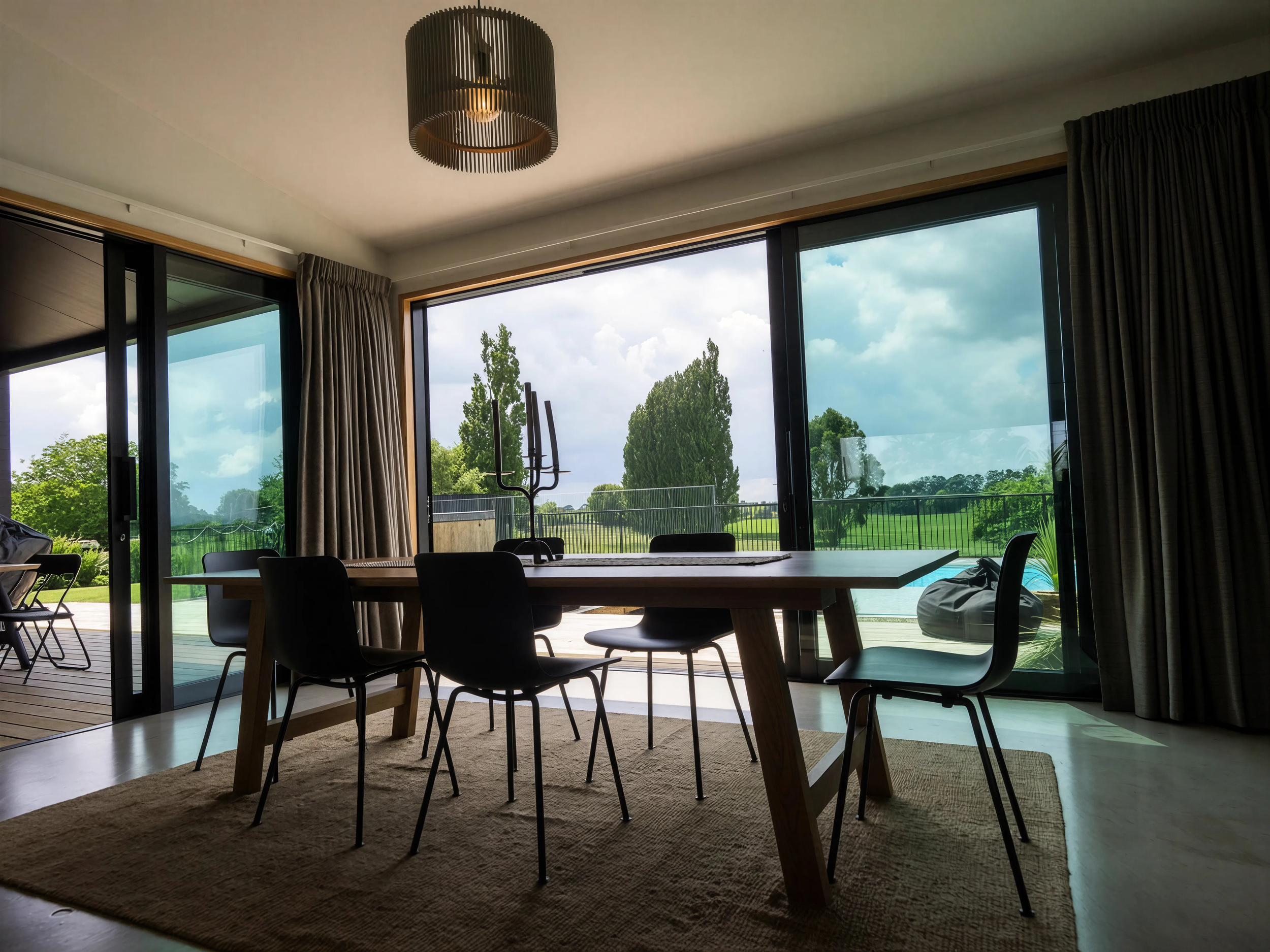 Interior, dining and living with expansive glazing framing the rural outlook
