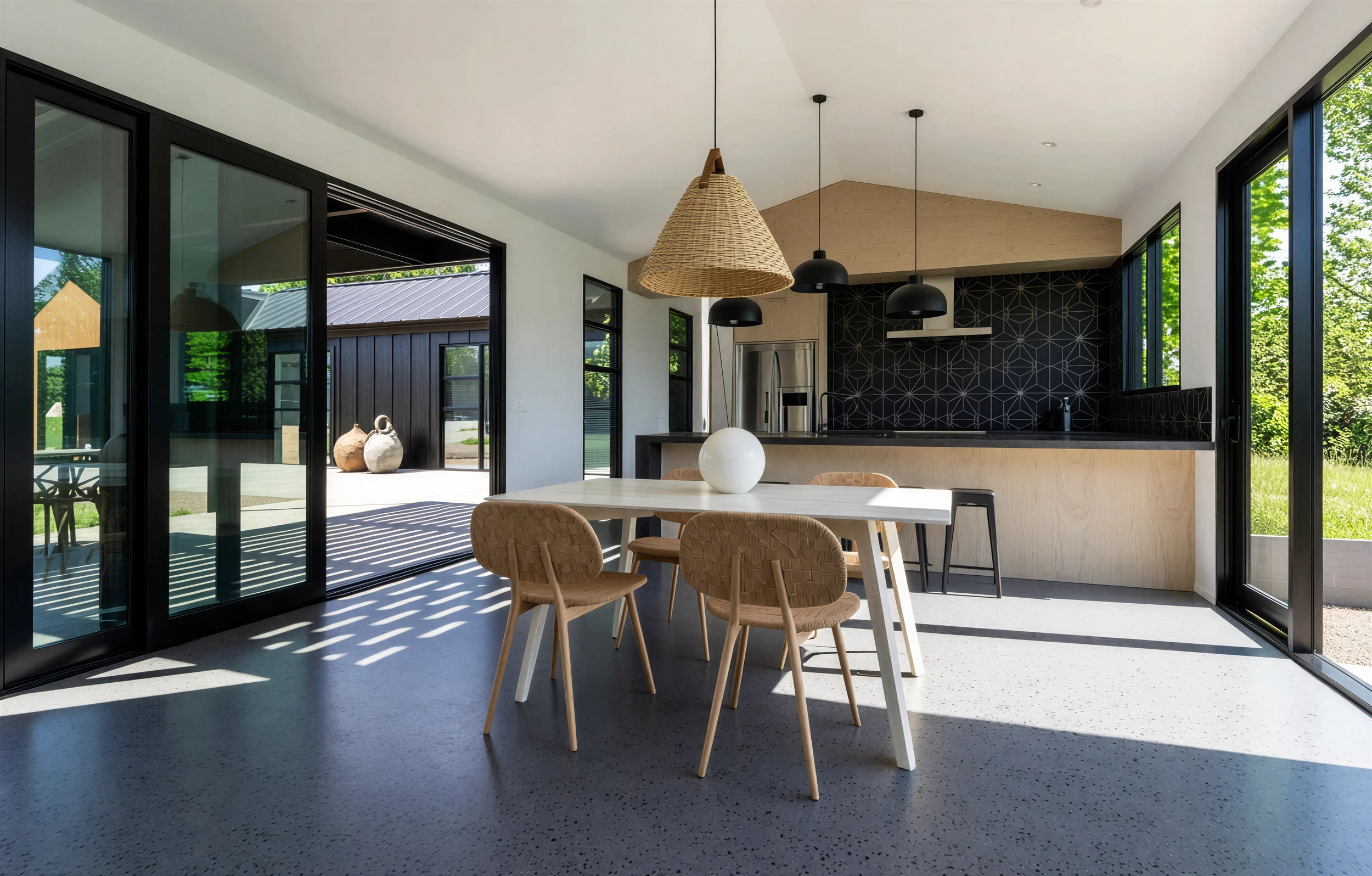 Open plan kitchen and dining with pendant lighting in a high performance rural family home
