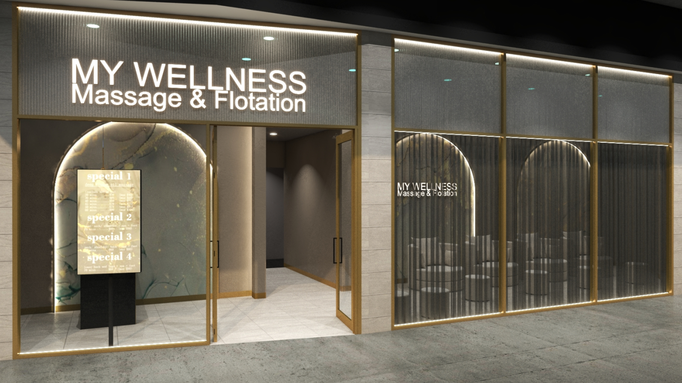 Exterior view of a wellness center called 'MY WELLNESS Massage & Flotation' with a glass door and a digital display board advertising special treatments, featuring modern design with illuminated sign and seating area inside.