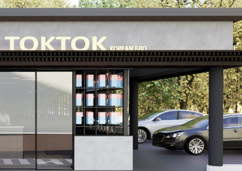 Exterior of a TikTok Korean BBQ restaurant with parked cars and a display of bottled drinks