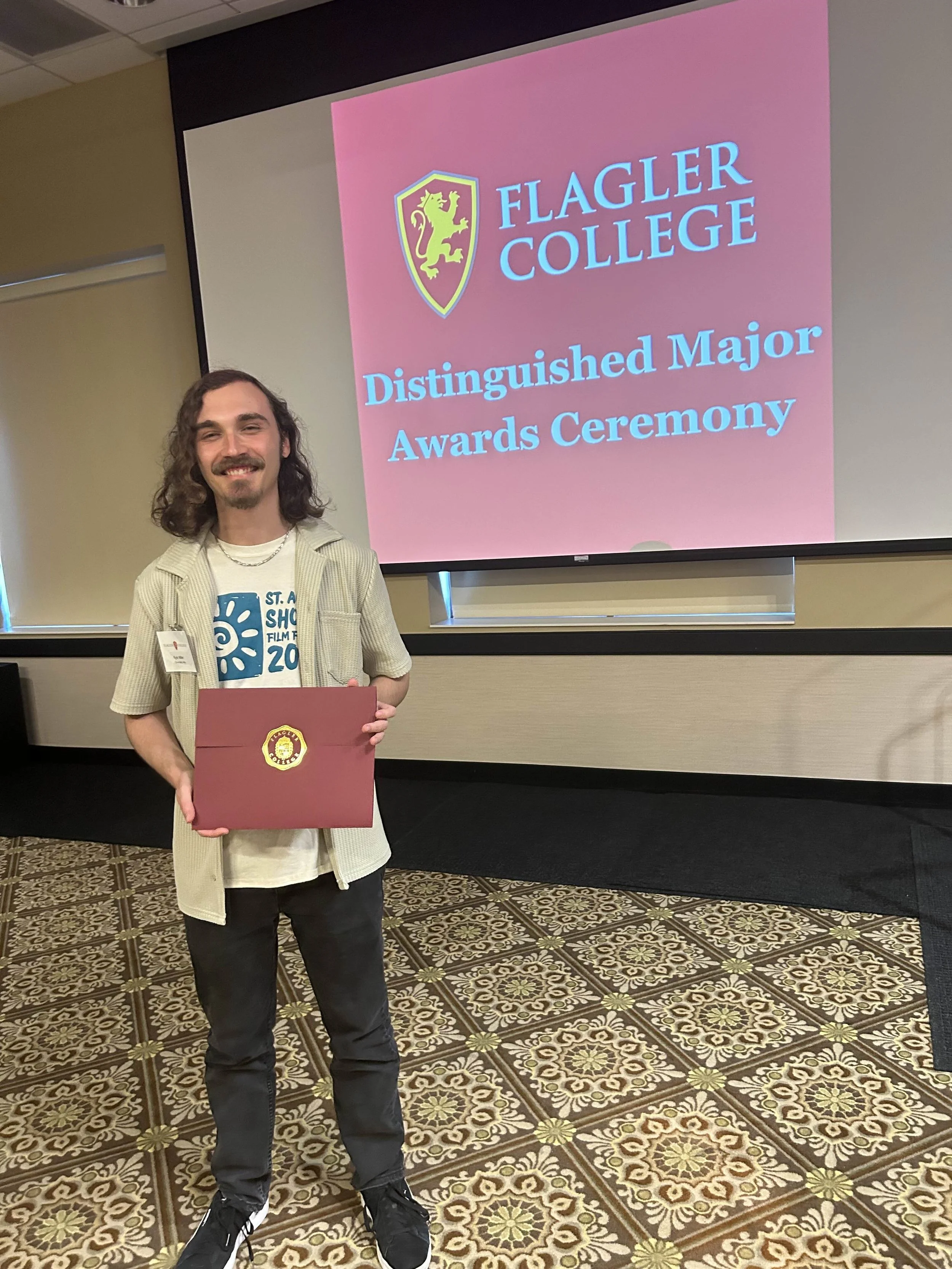 Kyle receiving awards at Flagler College