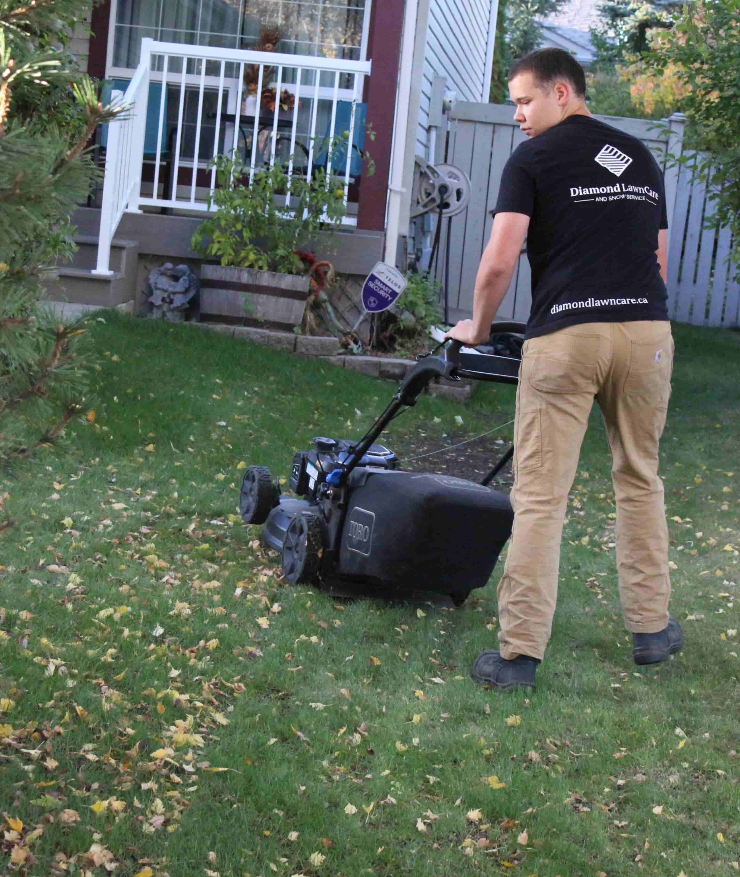 employee mowing lawn