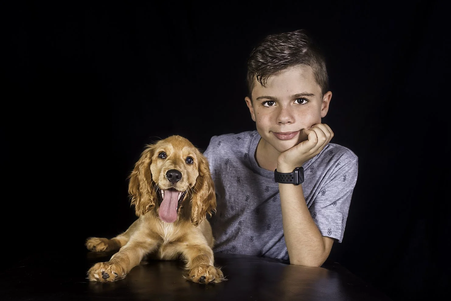 Gold Coast studio photography capturing family member with cute spaniel puppy.