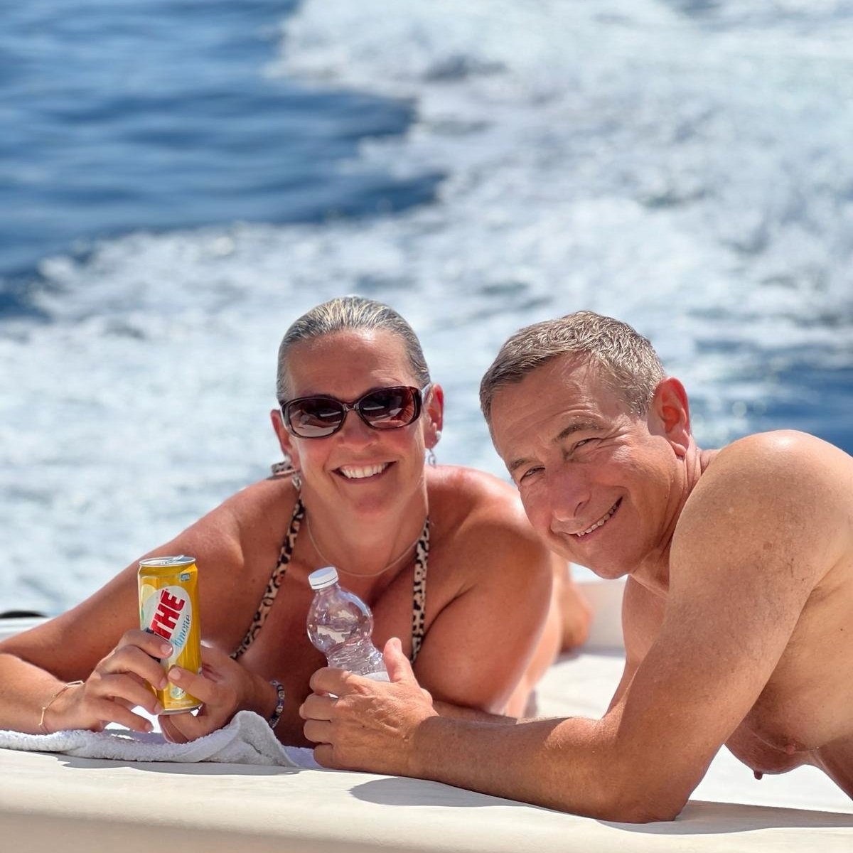Happy couple having fun and enjoying a boat tour to Capri