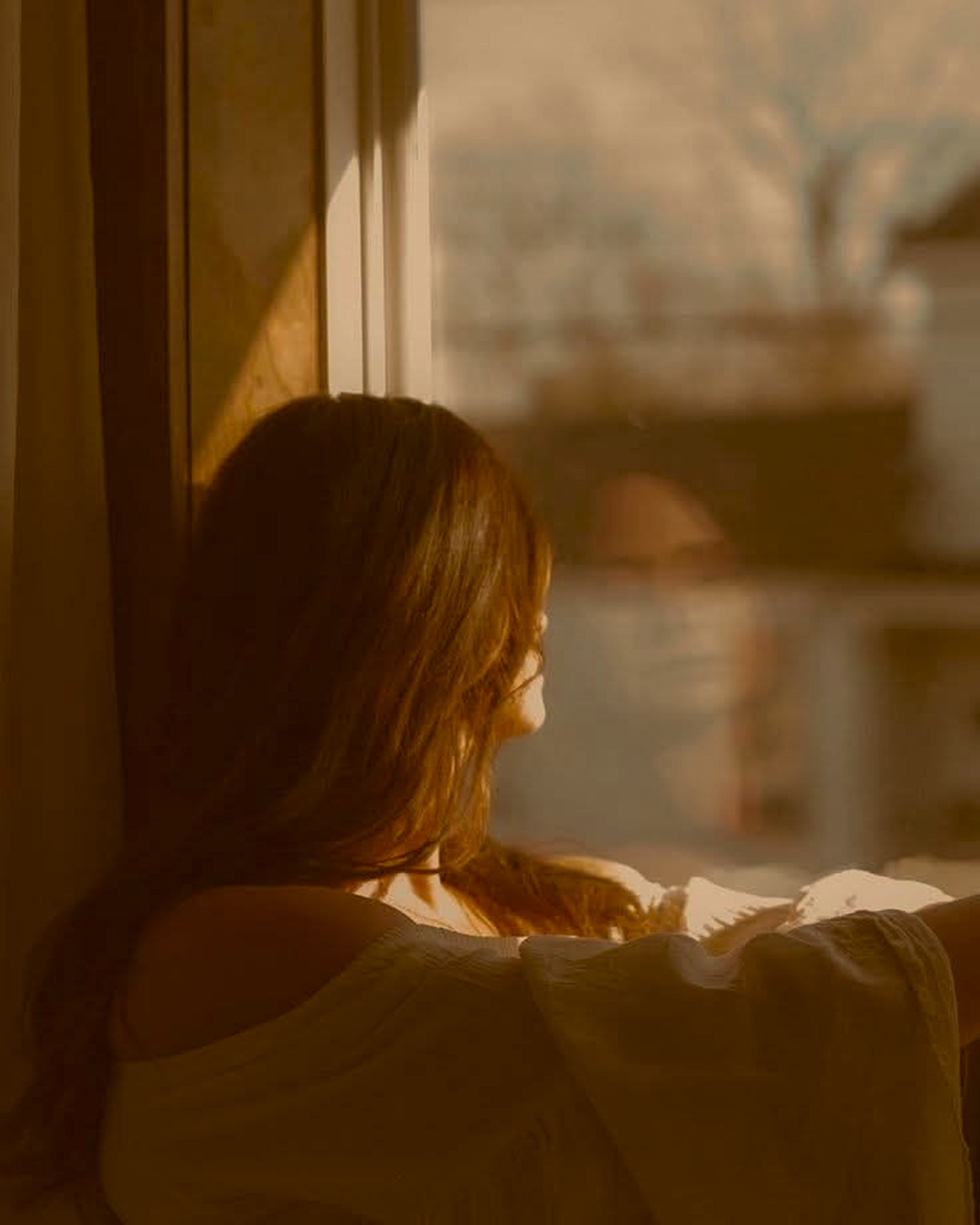 Woman sitting in reflection — on betrayal, open hearts, and learning to trust yourself again.