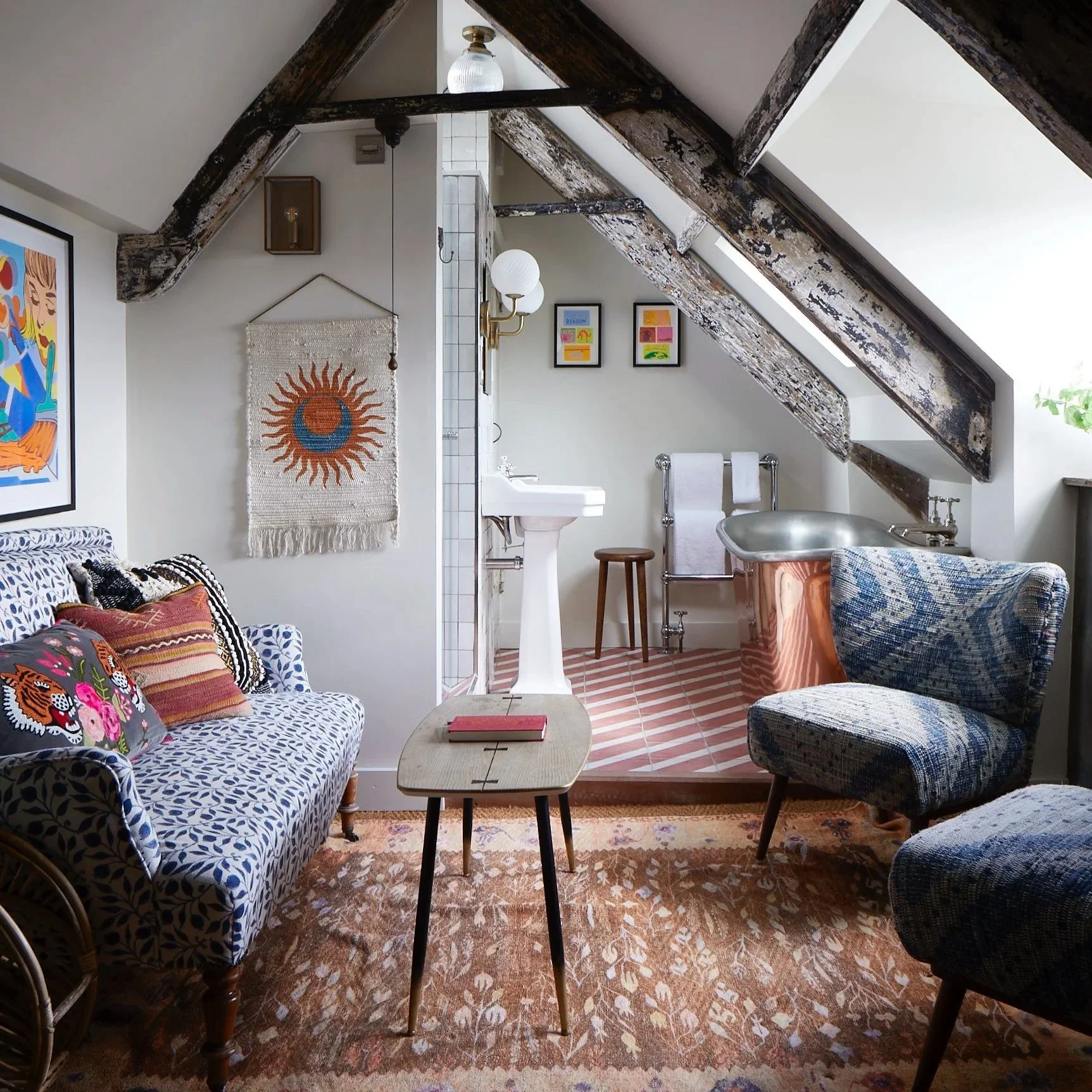 Artist Residence Penzance  - a characterful Mini Lookout  with layered prints, exposed beams and a freestanding bath tucked beneath the eaves.