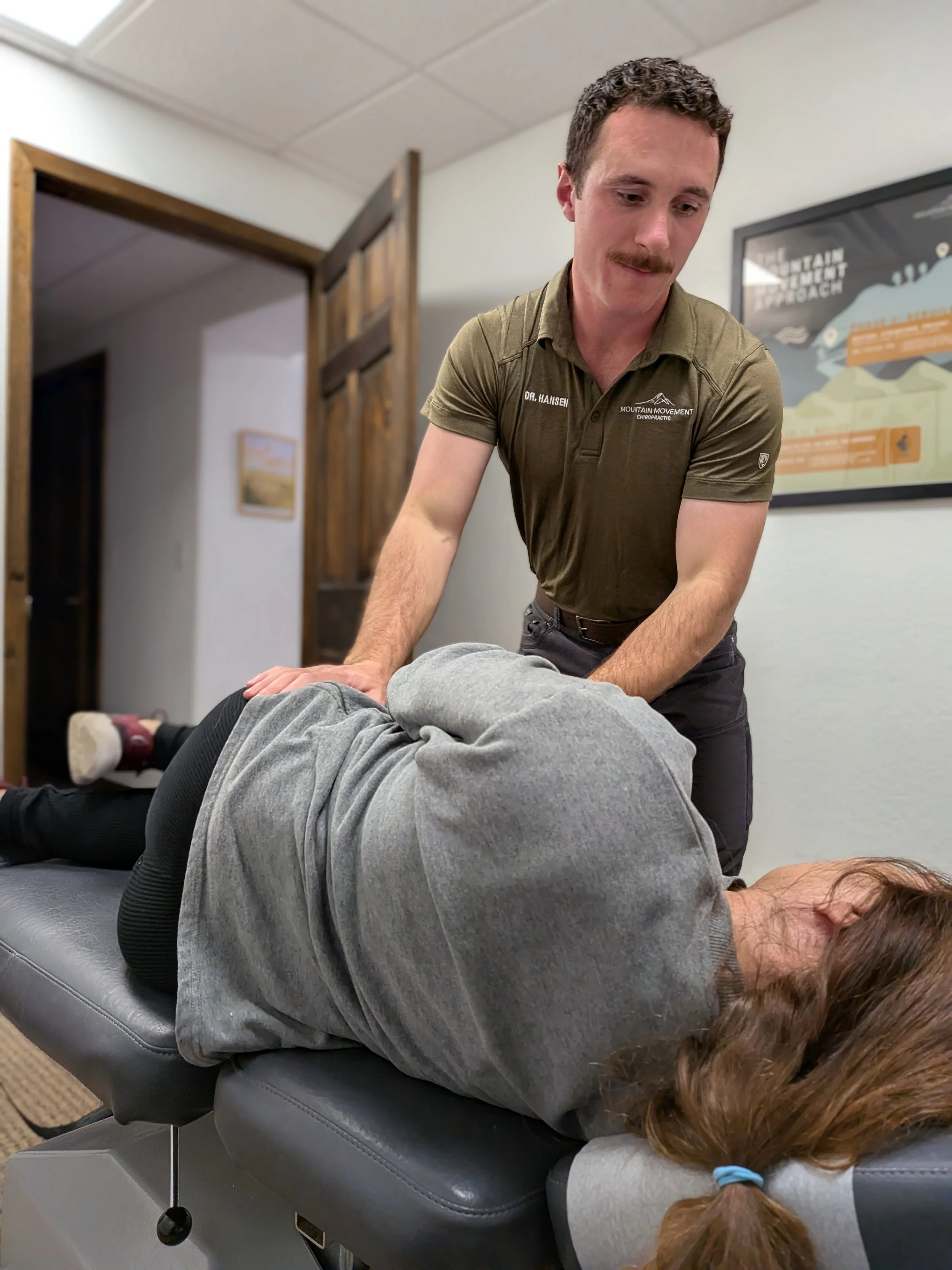Spearfish chiropractor Dr. Zach Hansen performing a side-lying chiropractic adjustment