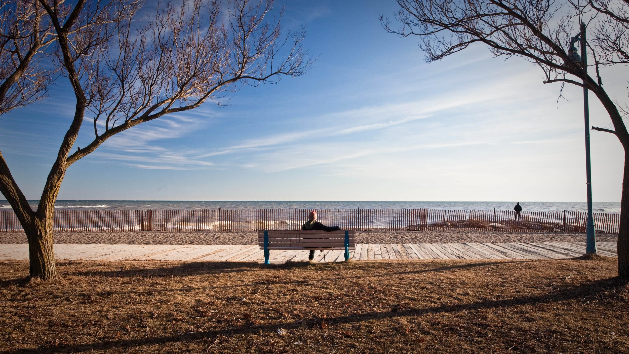 a warm winter day when sitting on a park bench