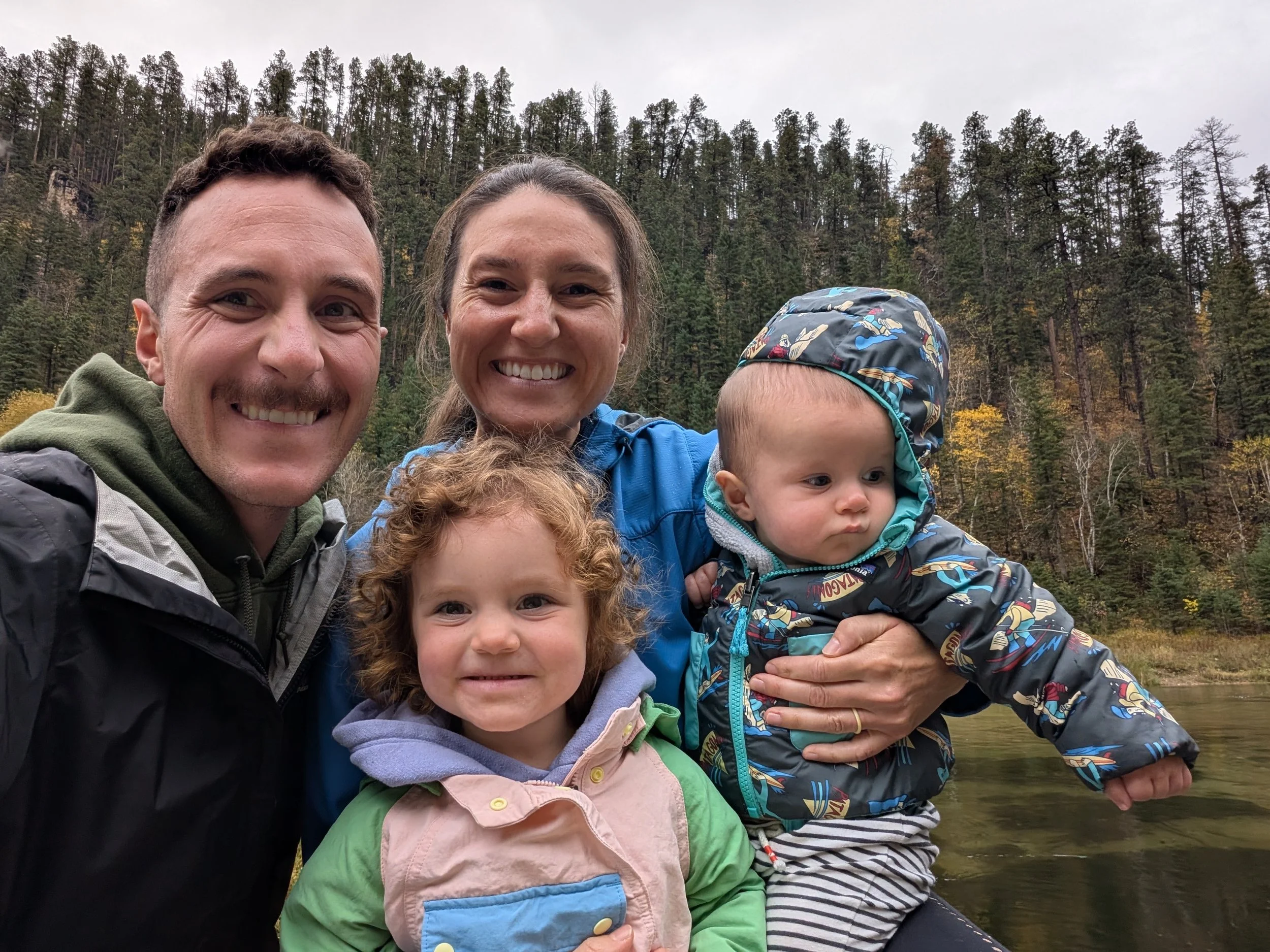 Dr. Zach Hansen with his wife and children outdoors in the Black Hills