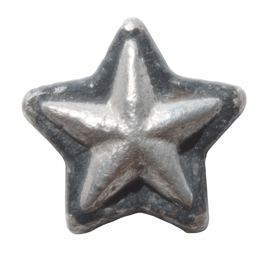 Close-up of a metallic star-shaped object with a shiny surface and some scratches.