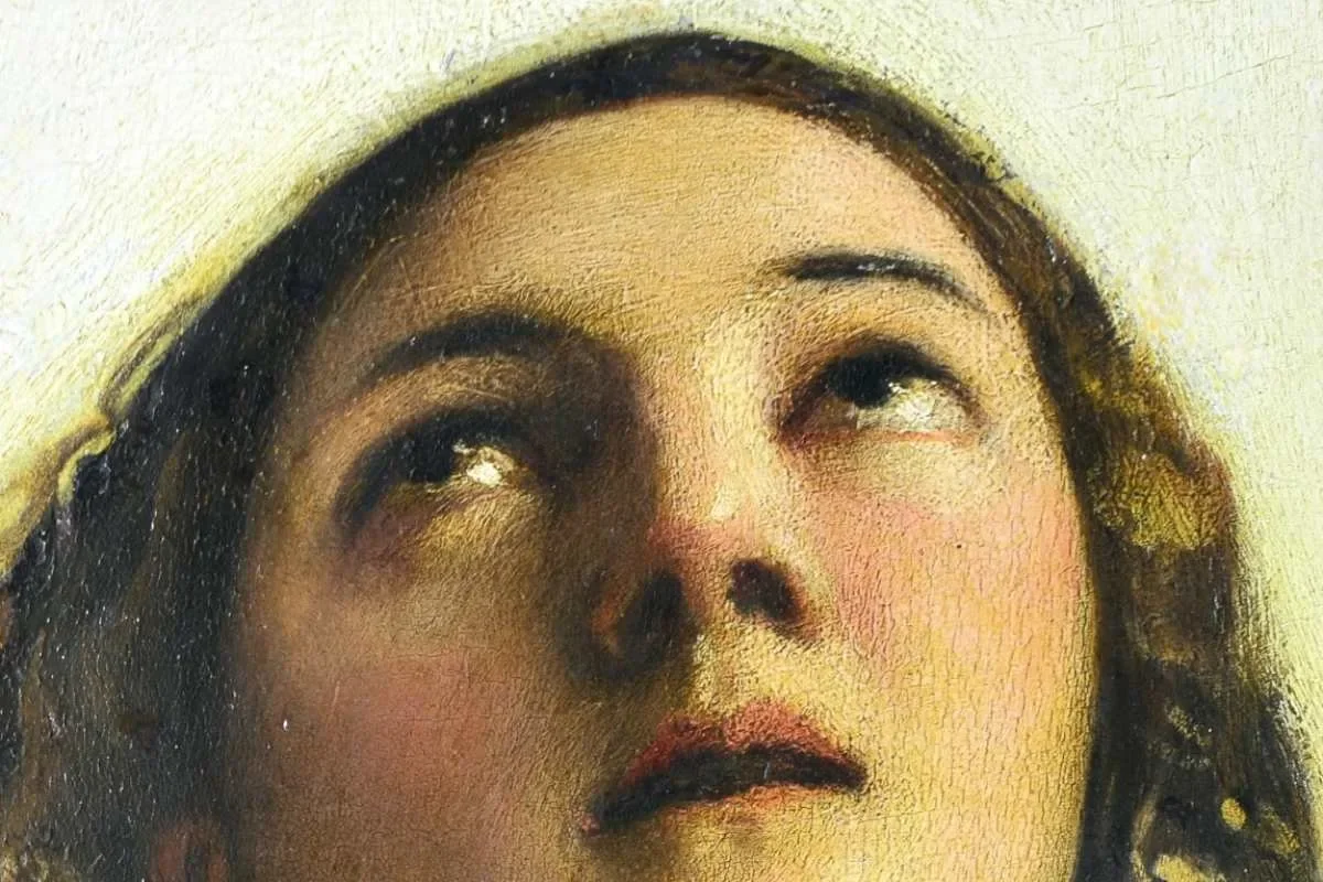 Detail of a classical oil painting by Tiziano showing Mary with dark hair gazing upward in serene devotion and spiritual contemplation.