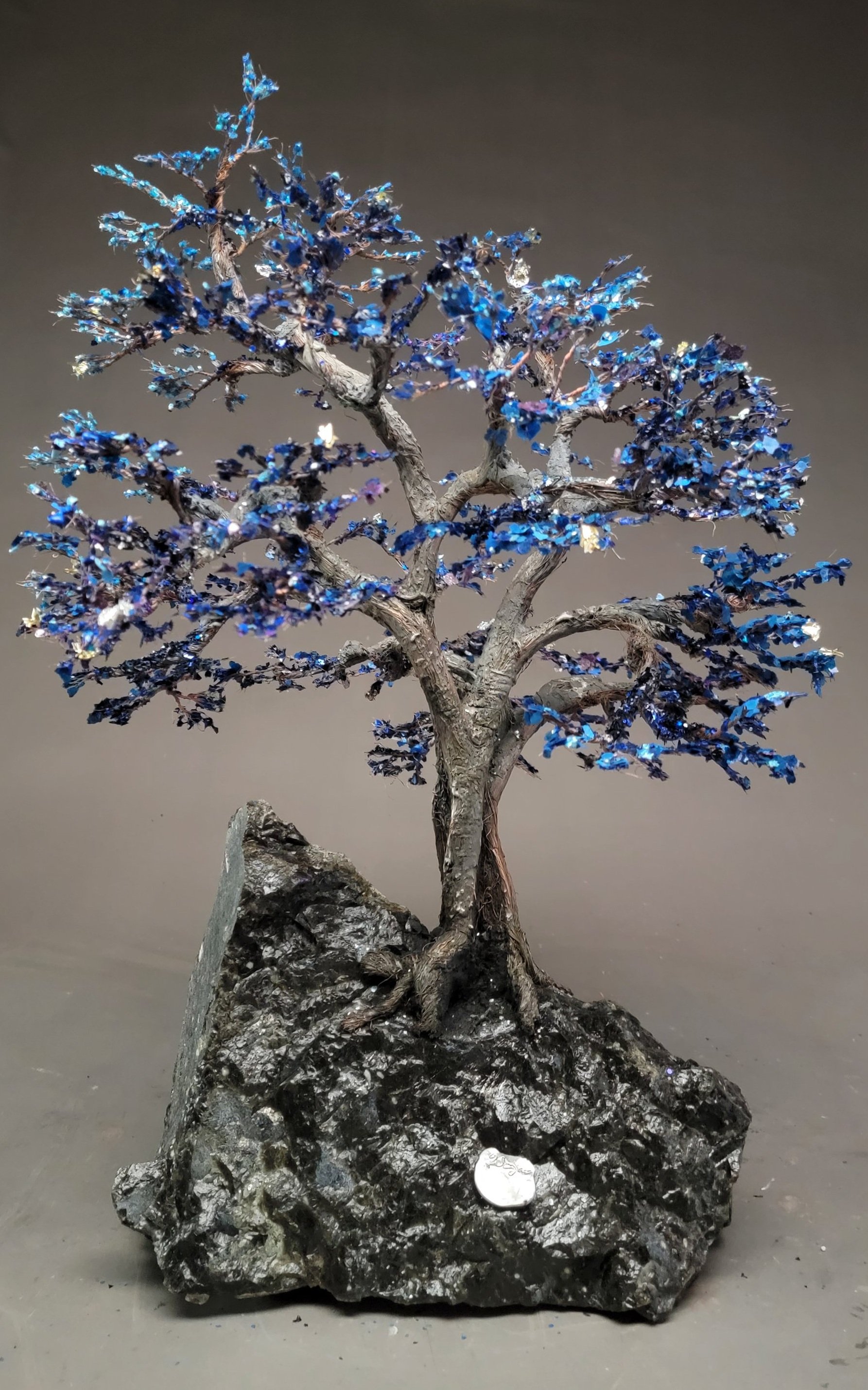 “Starry Night” is a whimsical wire tree sculpture inspired by Van Gogh’s iconic painting. Crafted from recycled wire, polymer paint, and shimmering mica chips, it’s a reminder that not every tree has to be rooted in reality — some are meant to dream.