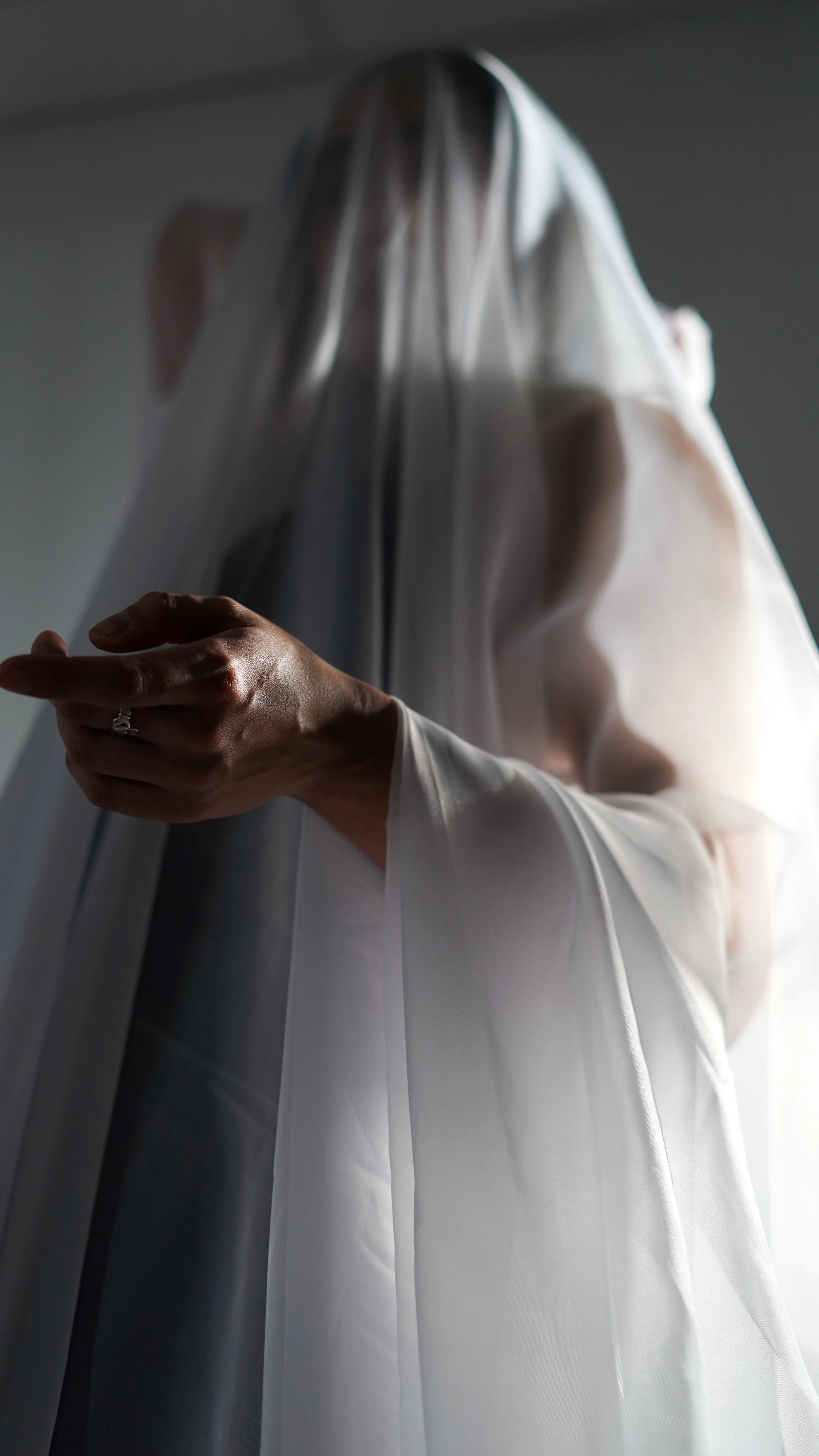 Sheer draped over a woman with dramatic lighting