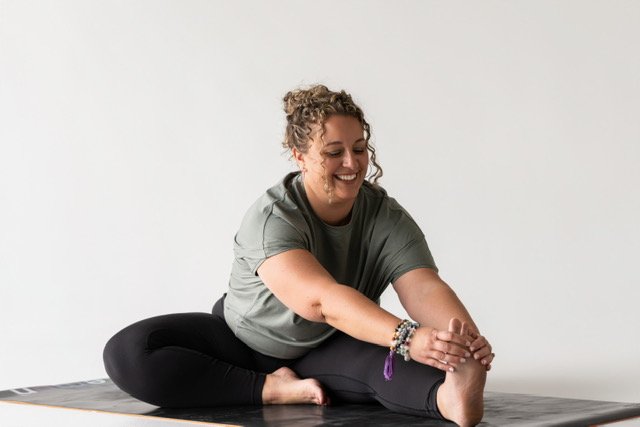 Retreat leader, yoga instructor and human design coach practicing a stretch