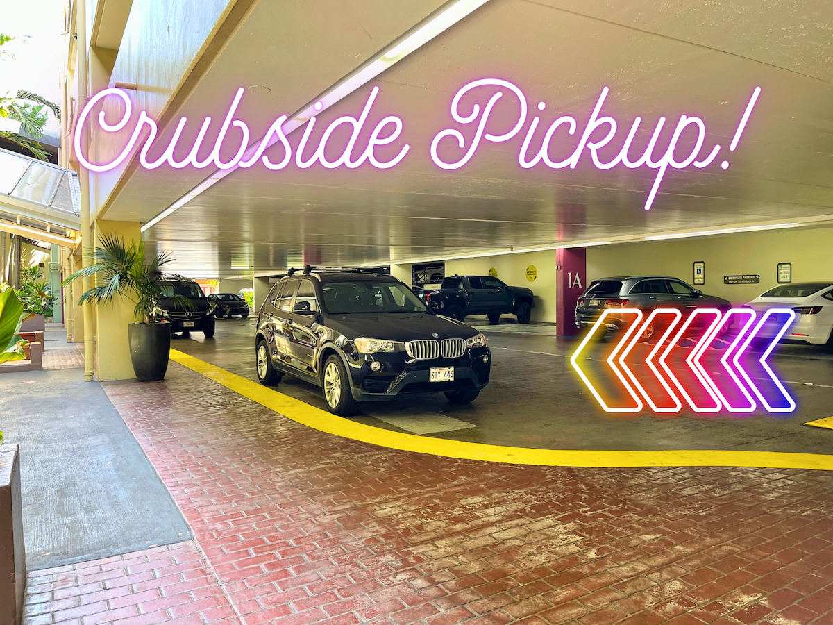 Underground parking area with a black BMW SUV parked near a yellow curb, potted plants, and neon signs that read 'Crubside Pickup!' and directional arrows in neon colors.