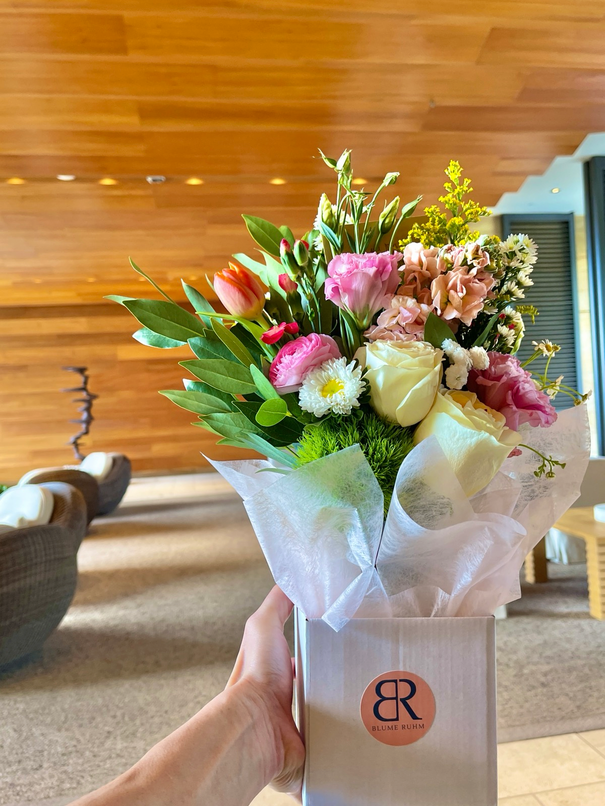 person holding mothers day arrangement roses tulips lisianthus 