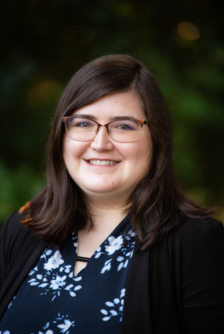 Woman with dark hair and glasses