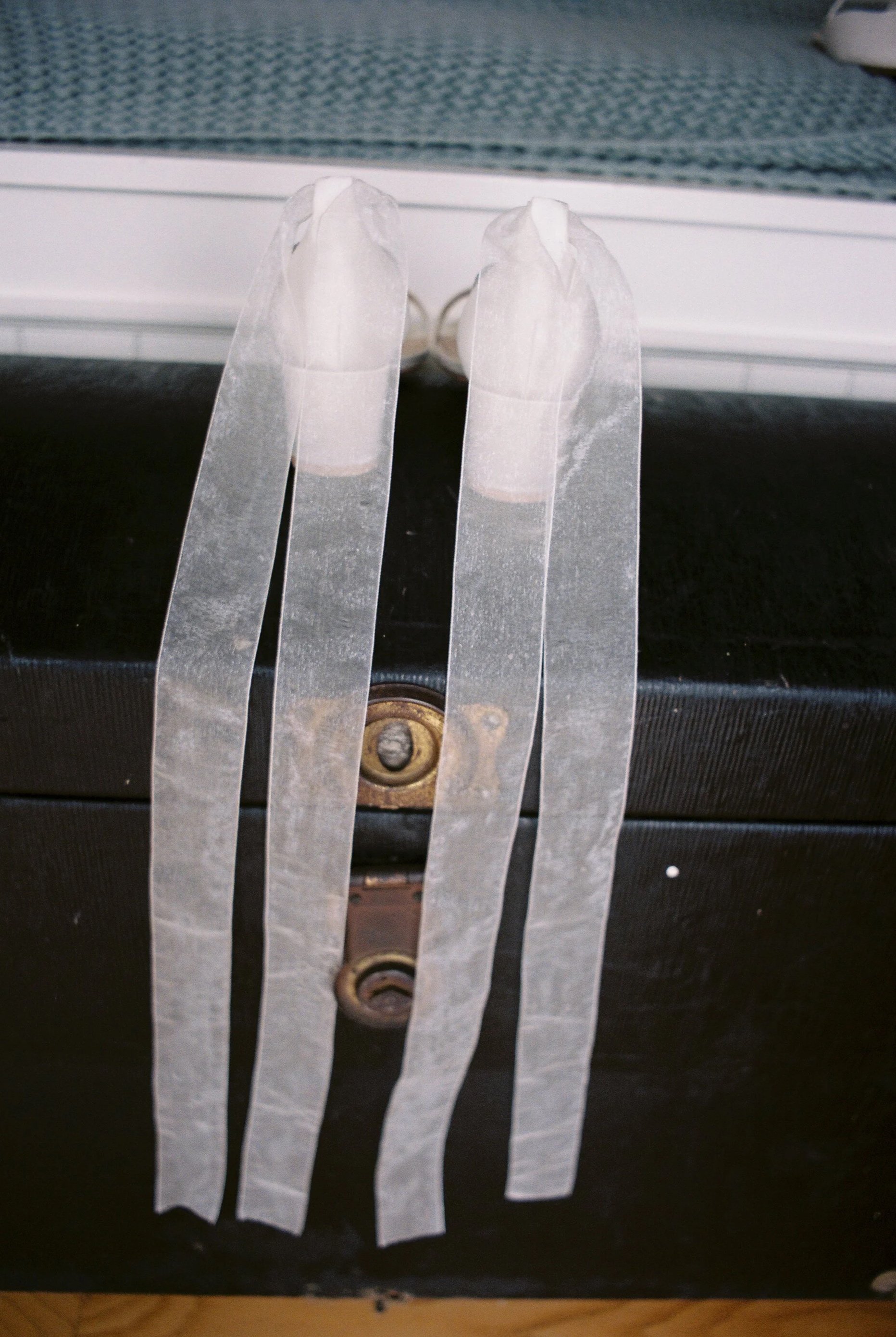 Ribbon on the brides wedding shoes dangling down.