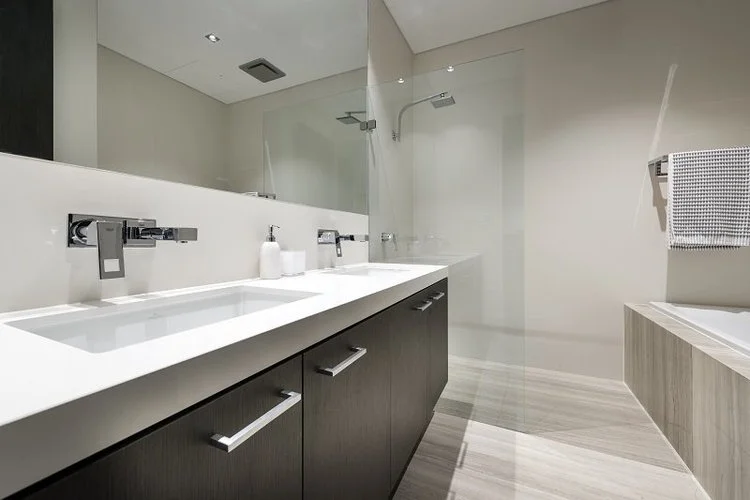 Dark floating vanity with double basin and walk-in shower — ensuite renovation Perth