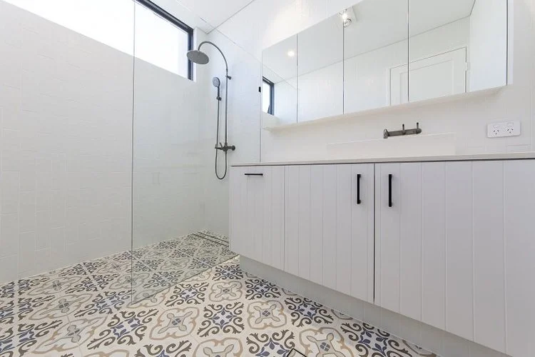 Walk-in shower with patterned floor tiles and white shaker vanity — bathroom renovation Perth