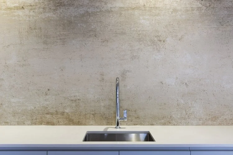 Contemporary stone-look splashback with stainless steel sink and chrome tap in a modern Mount Hawthorn home renovation by Renovation Lane WA.