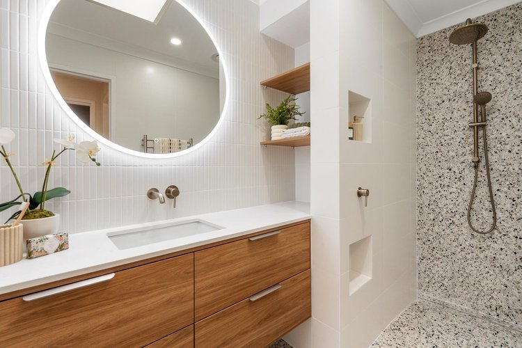 Timber vanity with round LED mirror and terrazzo walk-in shower — bathroom renovation Perth