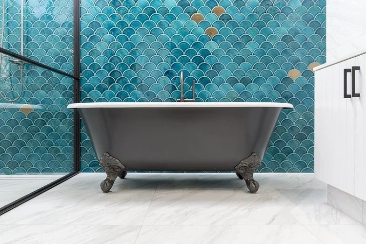 Clawfoot bath with teal fish-scale feature wall tiles — bathroom renovation Perth