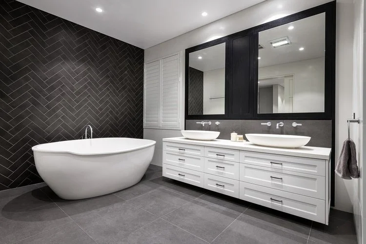Freestanding bath with black herringbone feature wall and double vanity — master ensuite renovation Perth