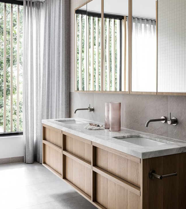 Contemporary double bathroom vanity with timber cabinetry, stone benchtop, wall-mounted taps and mirrored cabinets in a Mount Lawley bathroom renovation by Renovation Lane WA.