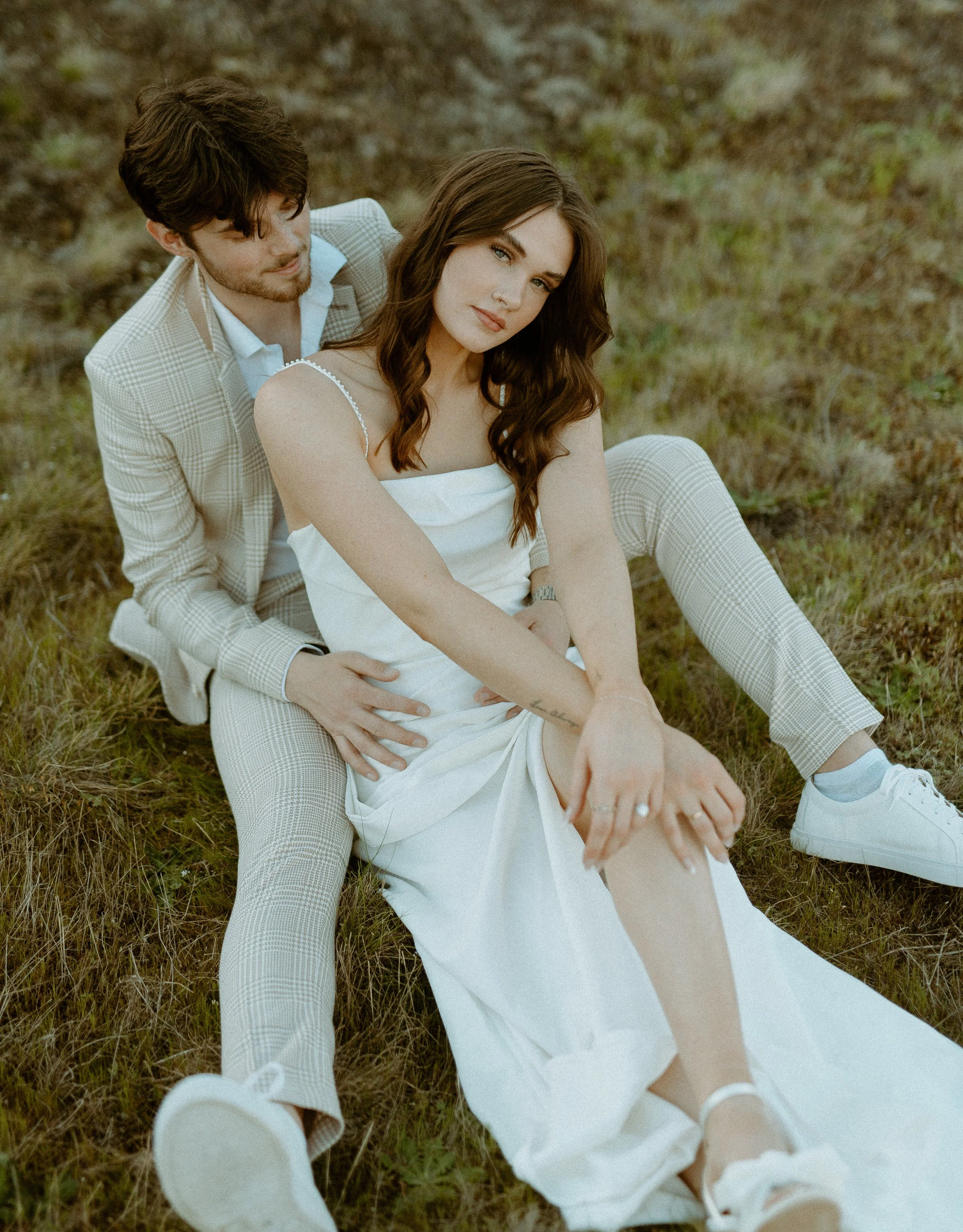 romantic couple sitting in grass during editorial bridal shoot at Chambers Bay Washington