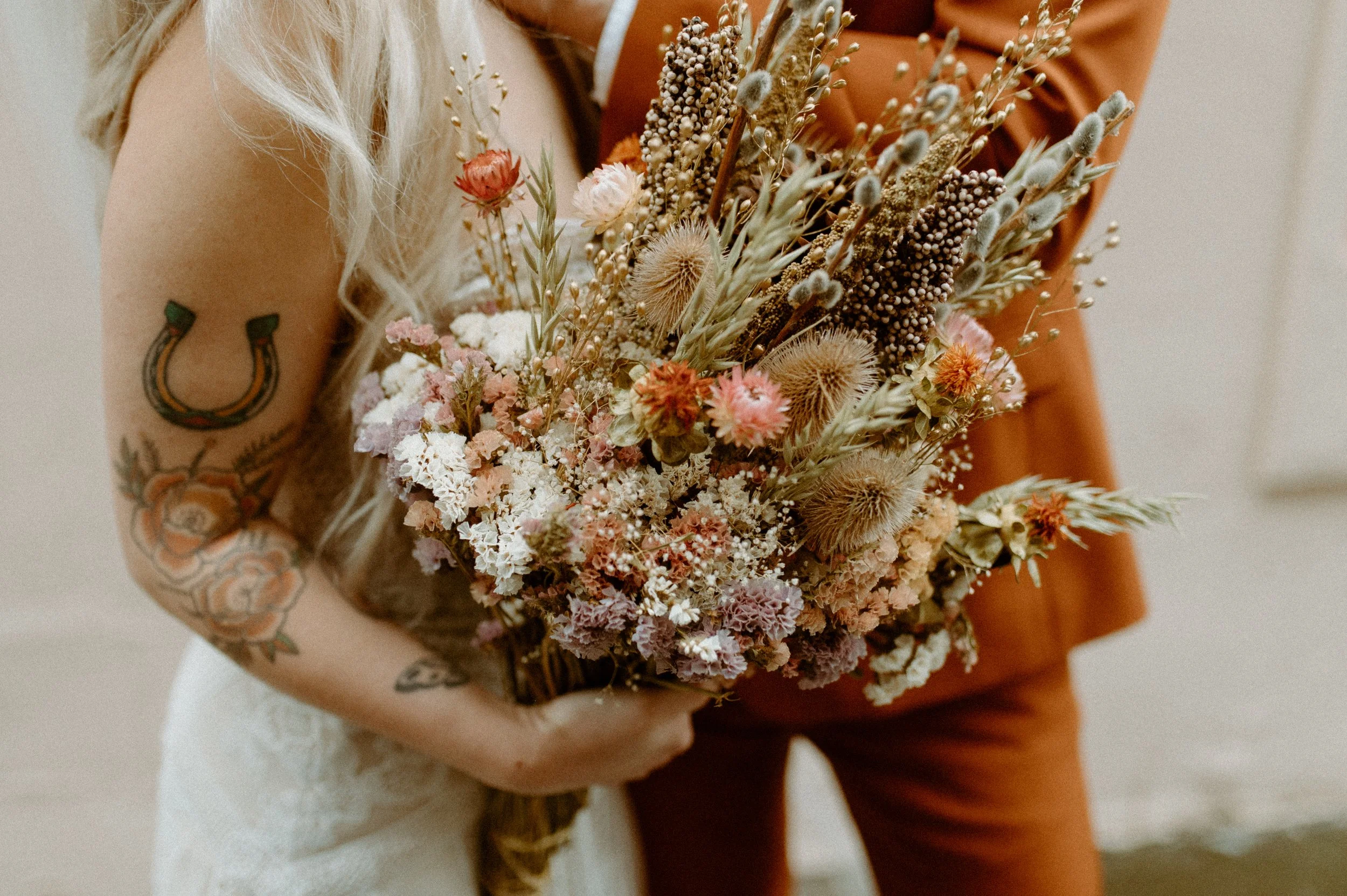 Close-up of bride holding a dried flower bouquet during a Seattle elopement