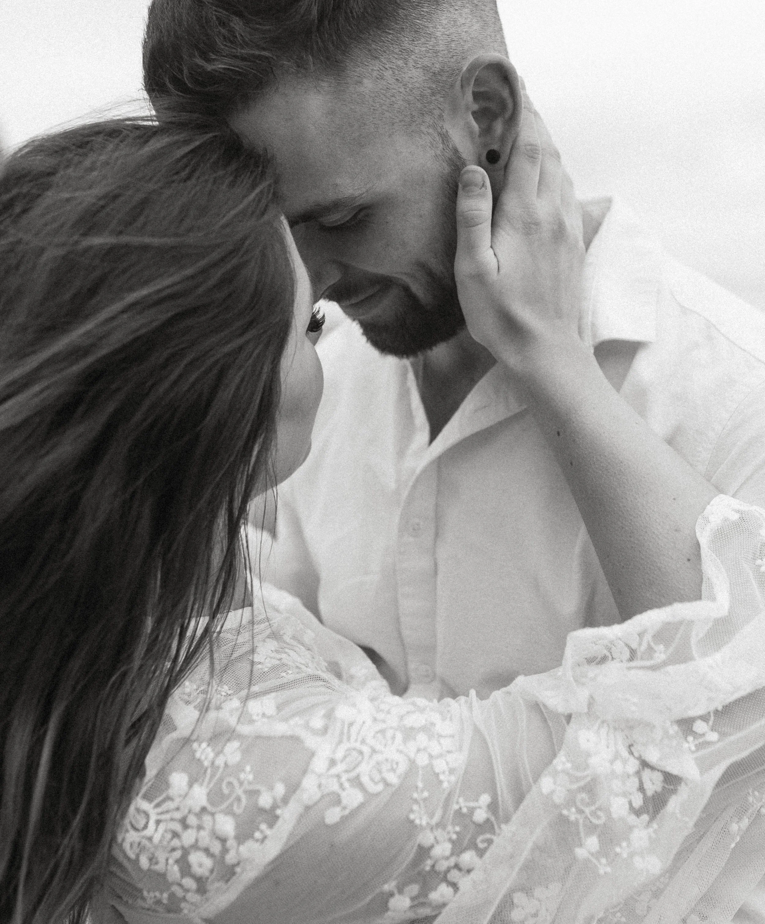 Black and white intimate moment between bride and groom during a windy Cannon Beach Oregon elopement